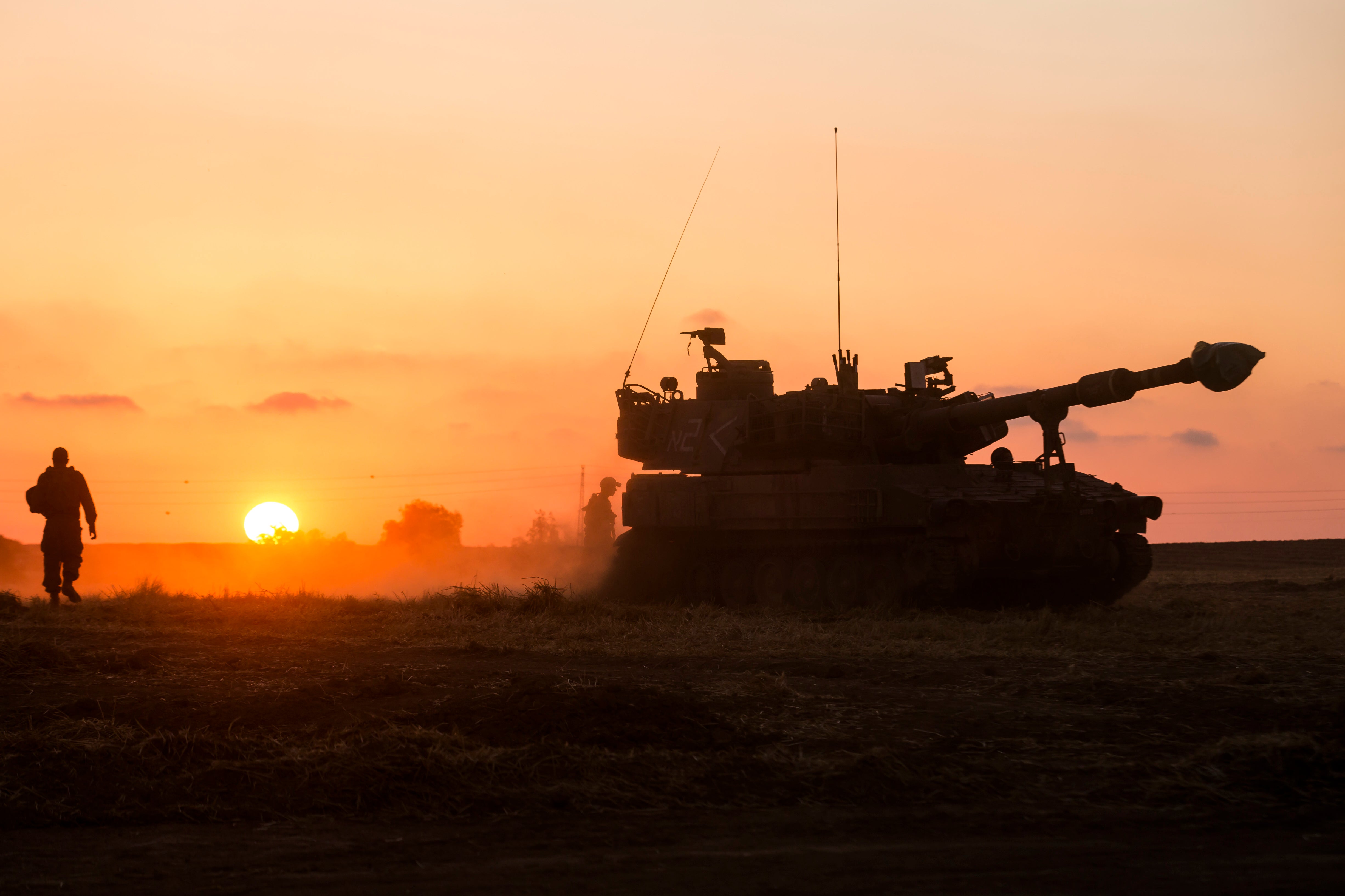 Israeli soldiers prepare an artillery unit near the border with the Gaza Strip