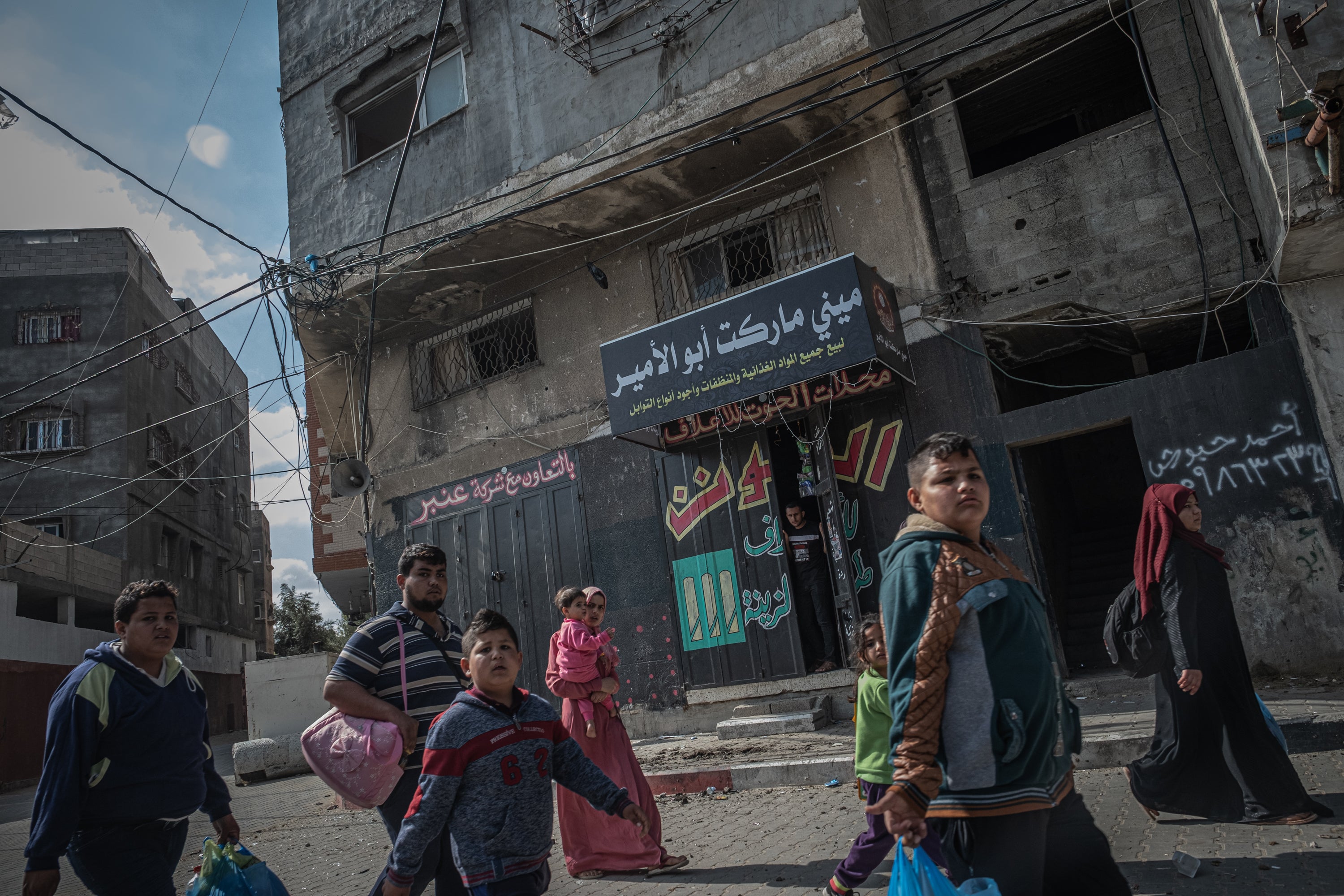 Palestinian families are seen after violent Israeli raids on the city of Beit Hanoun in northern Gaza