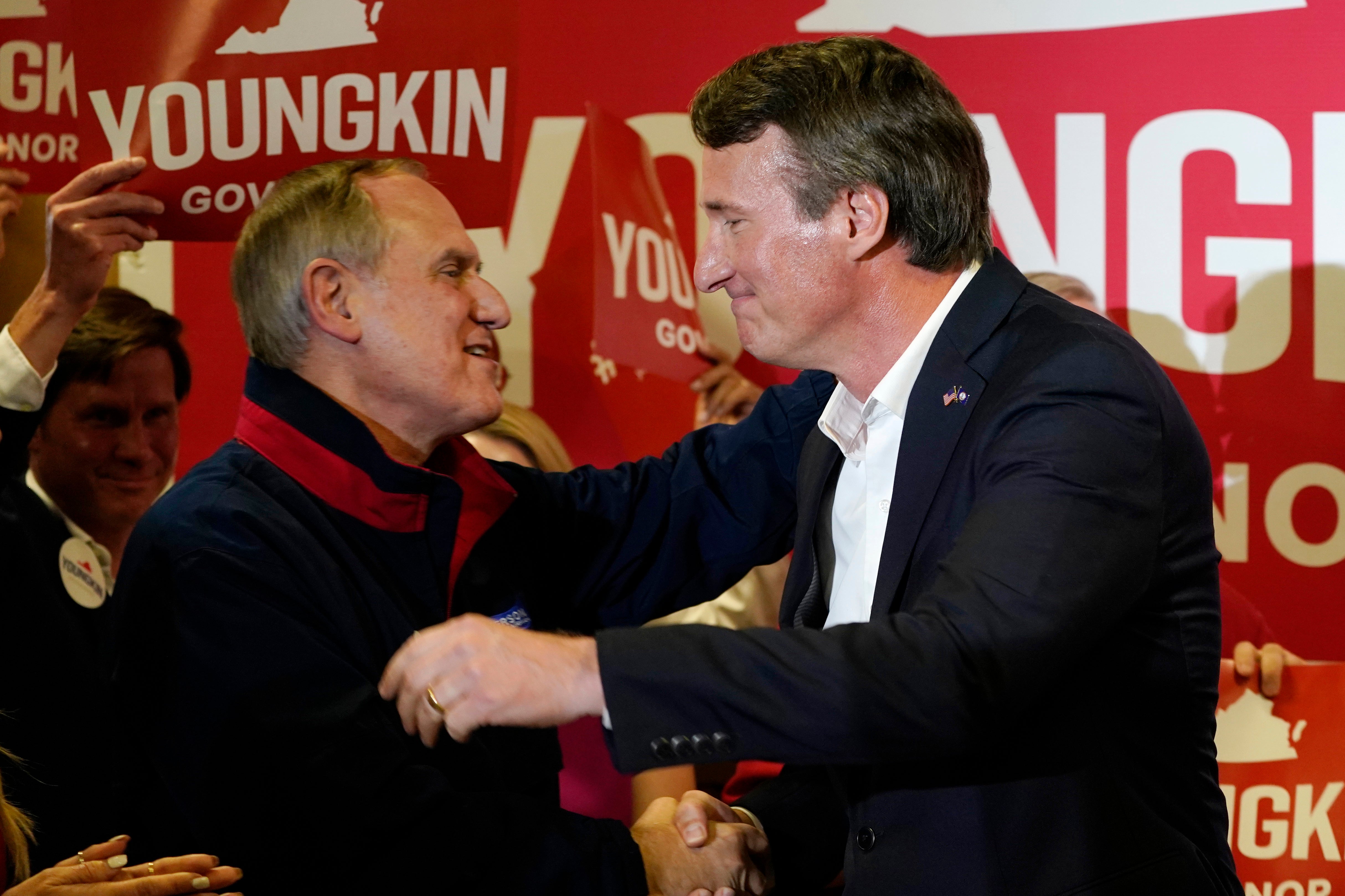 Republican gubernatorial candidate, Glen Youngkin, right, hugs Virginia Republican party chairman, Rich Anderson, as he arrives for an event in Richmond, Va., Tuesday, May 11, 2021.