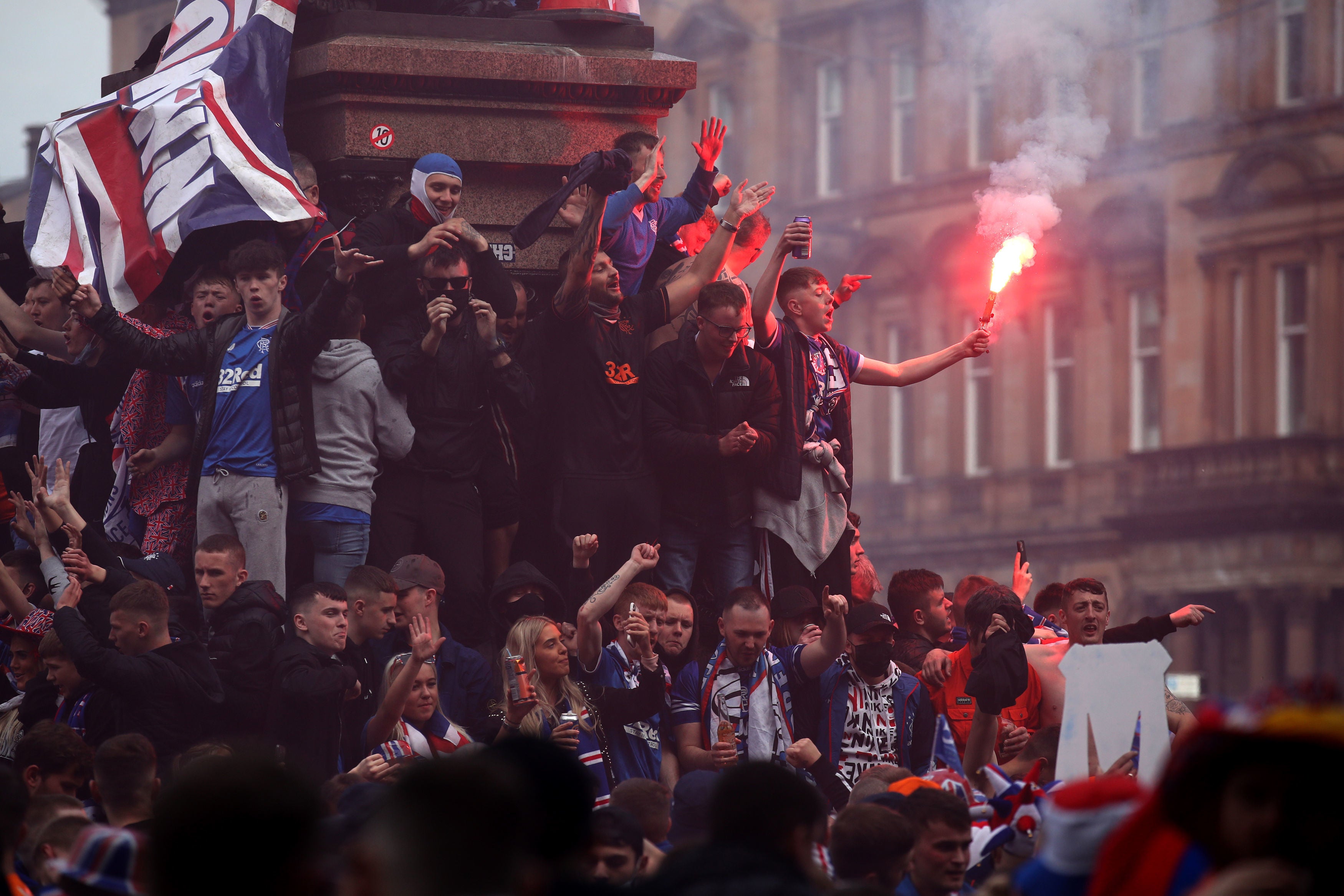 Rangers fans celebrate before being dispersed by police