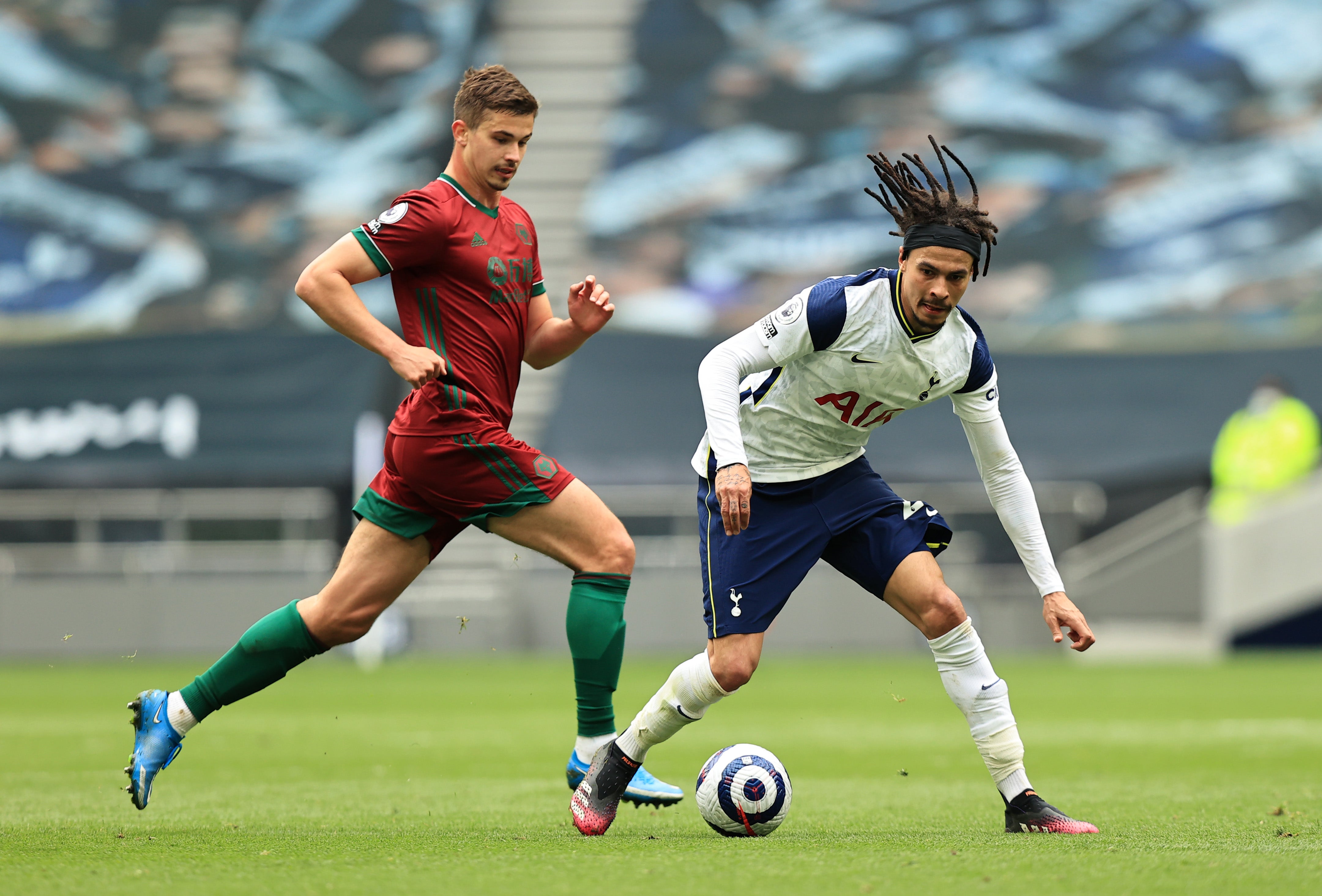 Dele Alli of Tottenham Hotspur gets past Leander Dendoncker of Wolverhampton Wanderers