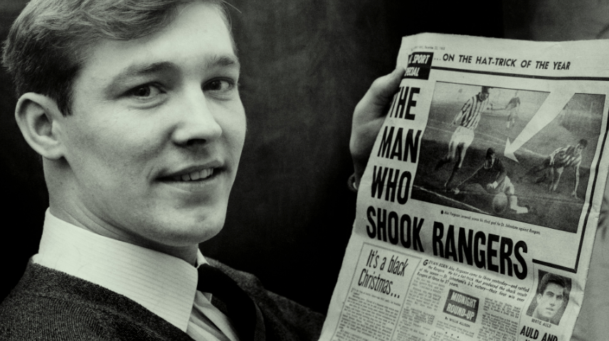 Sir Alex Ferguson poses with a newspaper after inspiring victory over Rangers