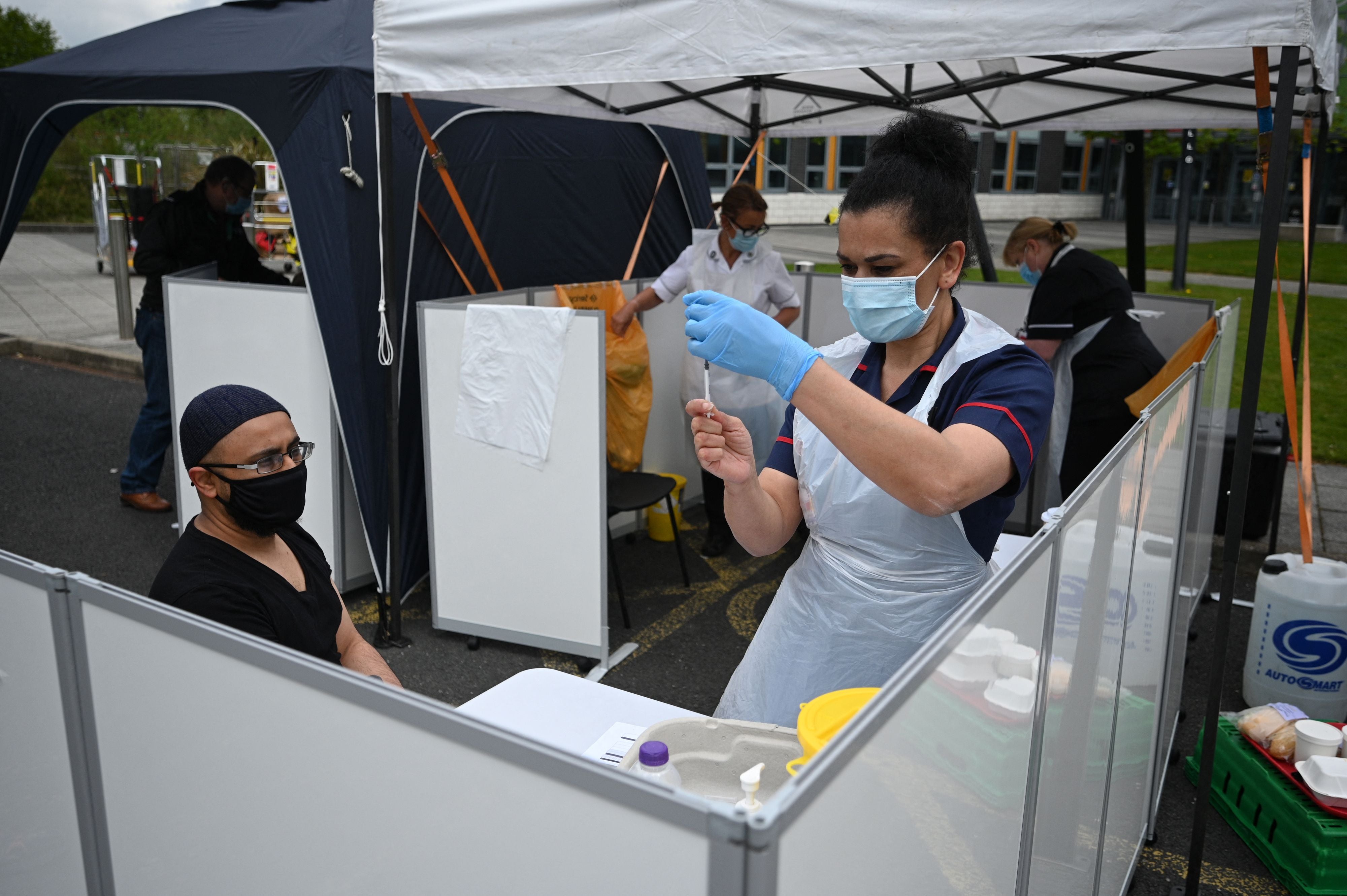 A member of the public receives a Covid-19 vaccine at a temporary vaccination centre at the Essa academy in Bolton, northwest England