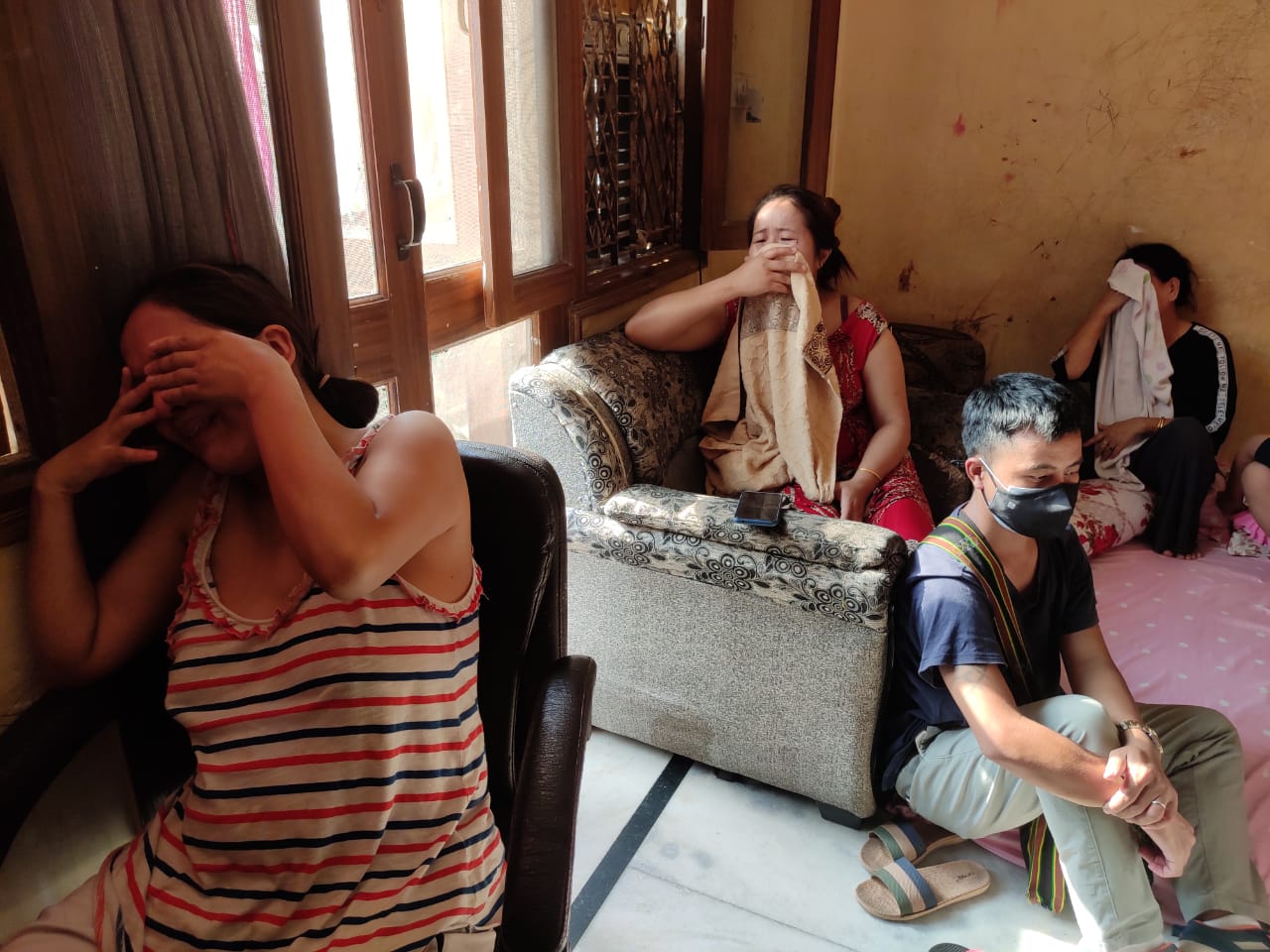 Sang Hlun Thang’s wife (left), sister and mother (right) cry inconsolably as they speak about his experience at a hospital in Delhi