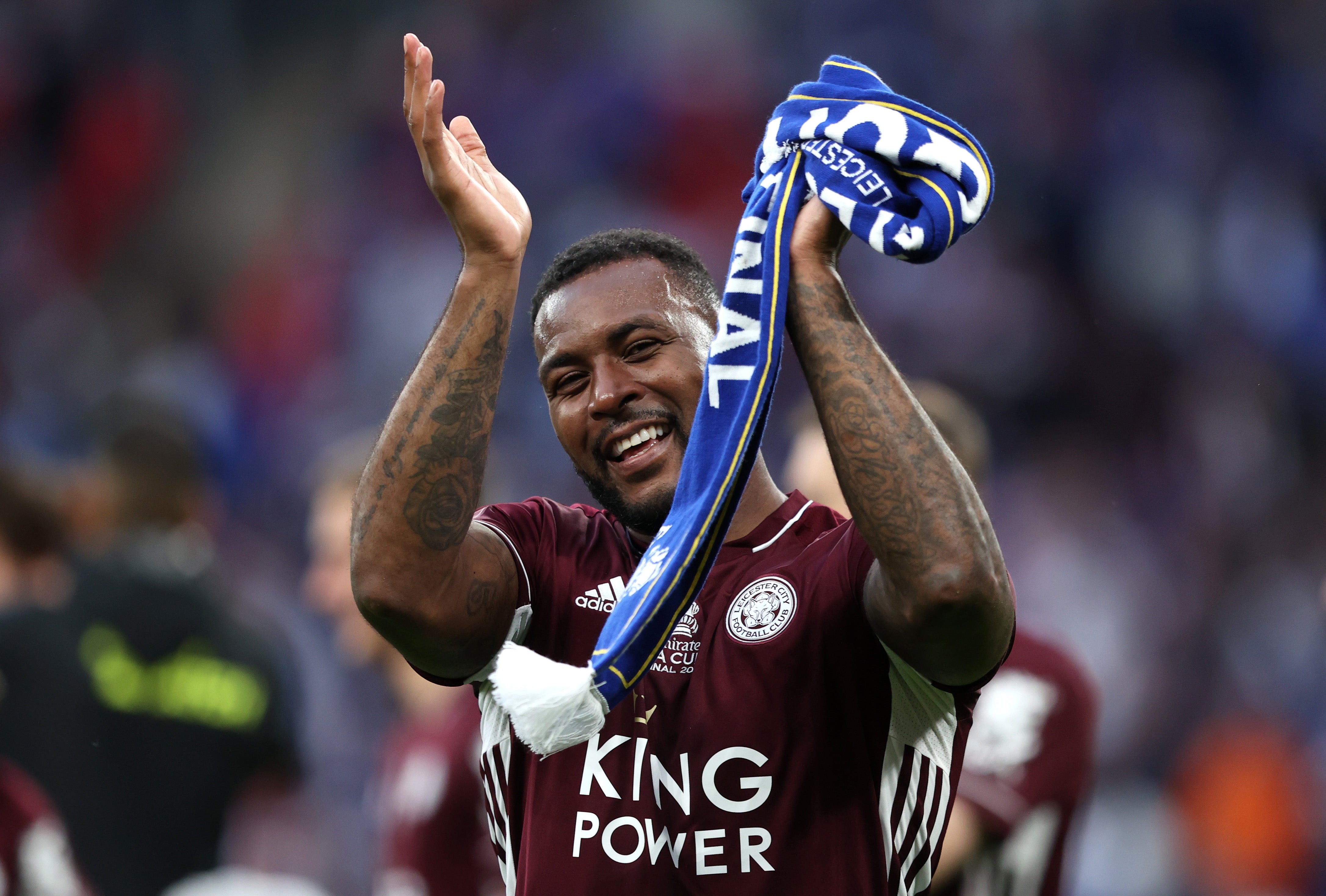 Wes Morgan celebrates with Leicester supporters at Wembley