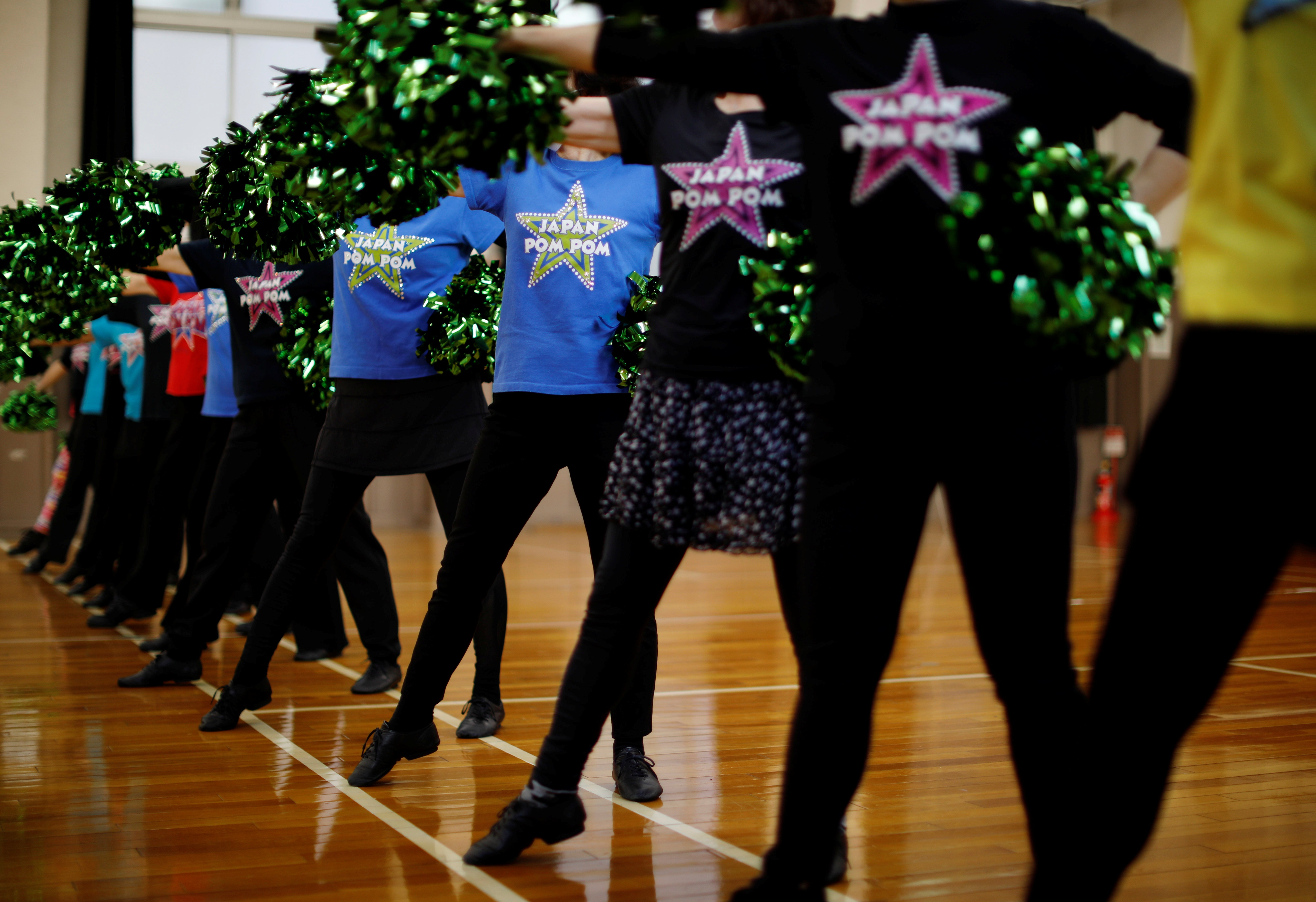 Members maintain social distancing as they practice a routine during a weekly practice session