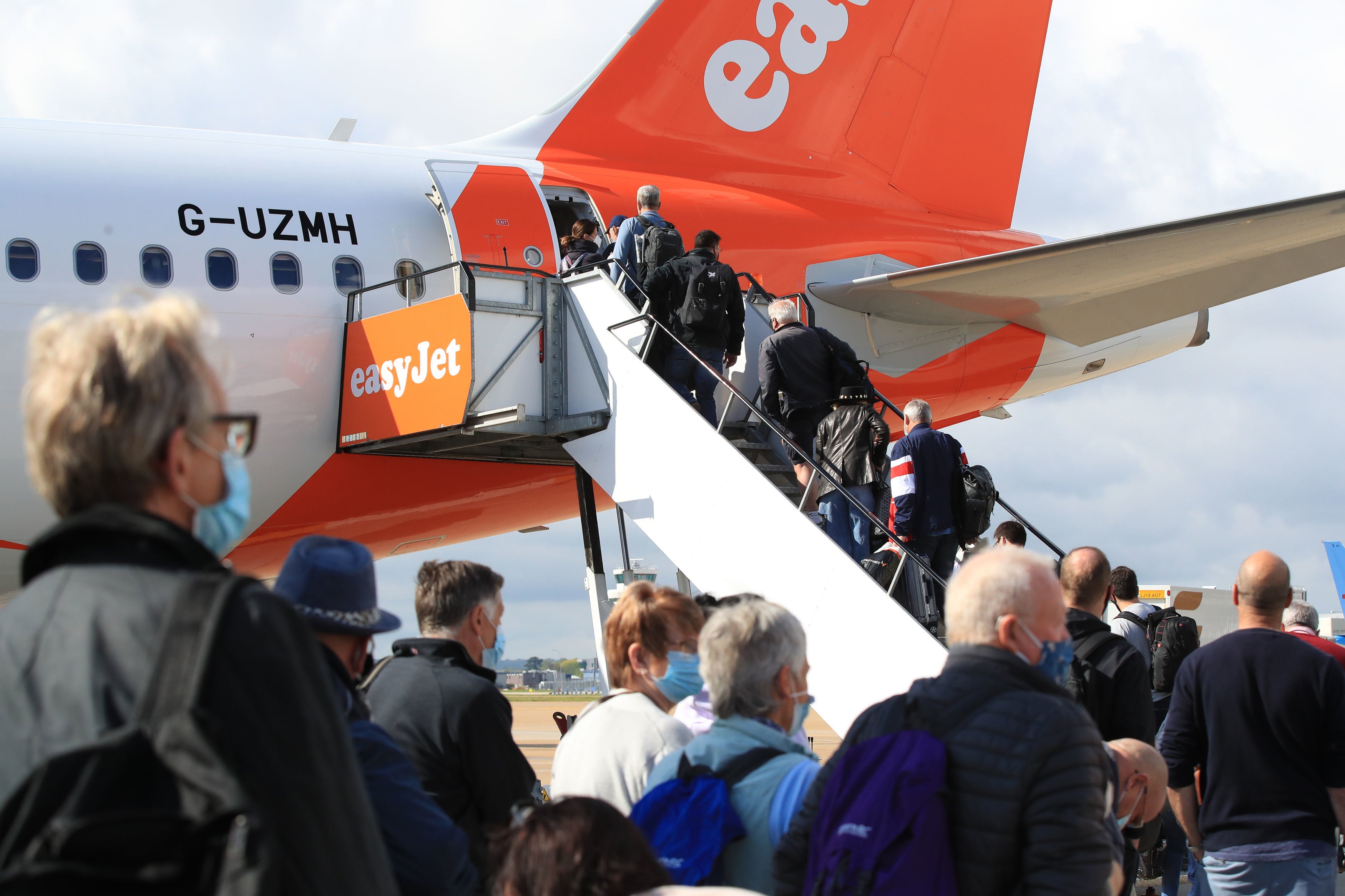 Passengers at Gatwick prepare to board an easyJet flight to Faro, Portugal, on Monday