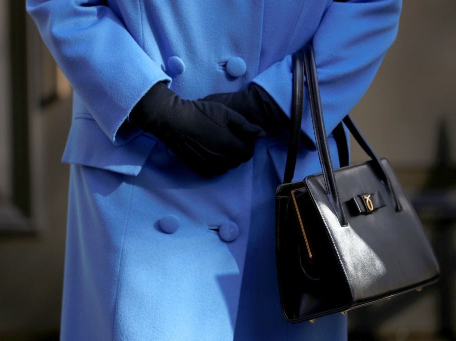 Queen Elizabeth II, handbag and gloves detail, marks the centenary of GCHQ (Government Communications Head Quarters) at Watergate House