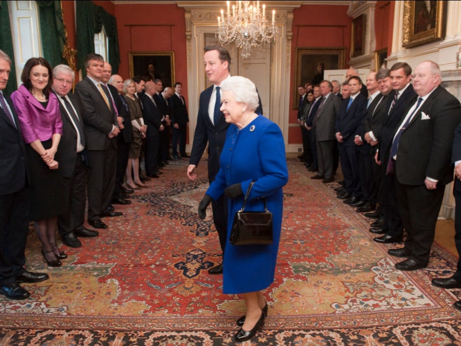 Queen Elizabeth II arrives with British Prime Minister David Cameron to meet members of the cabinet at Number 10 Downing Street as she attends the Government’s weekly Cabinet meeting on December 2012 in London