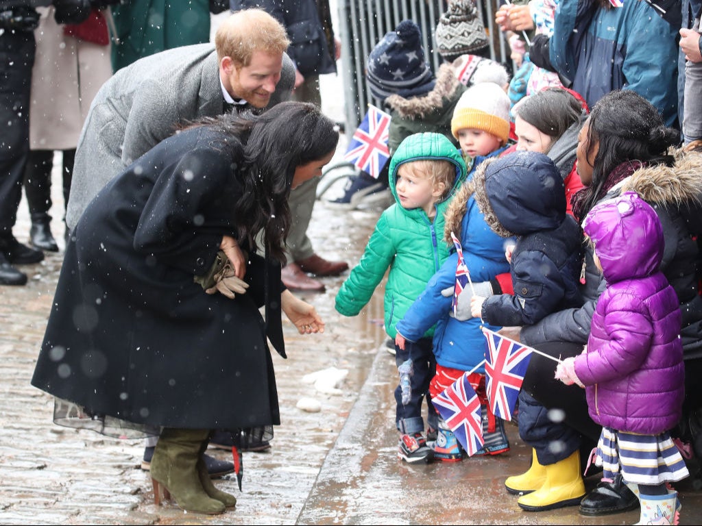 Meghan, Duchess of Sussex and Prince Harry, Duke of Sussex meet children in the crowd as they arrive at the Bristol Old Vic on 1 February 2019 in Bristol