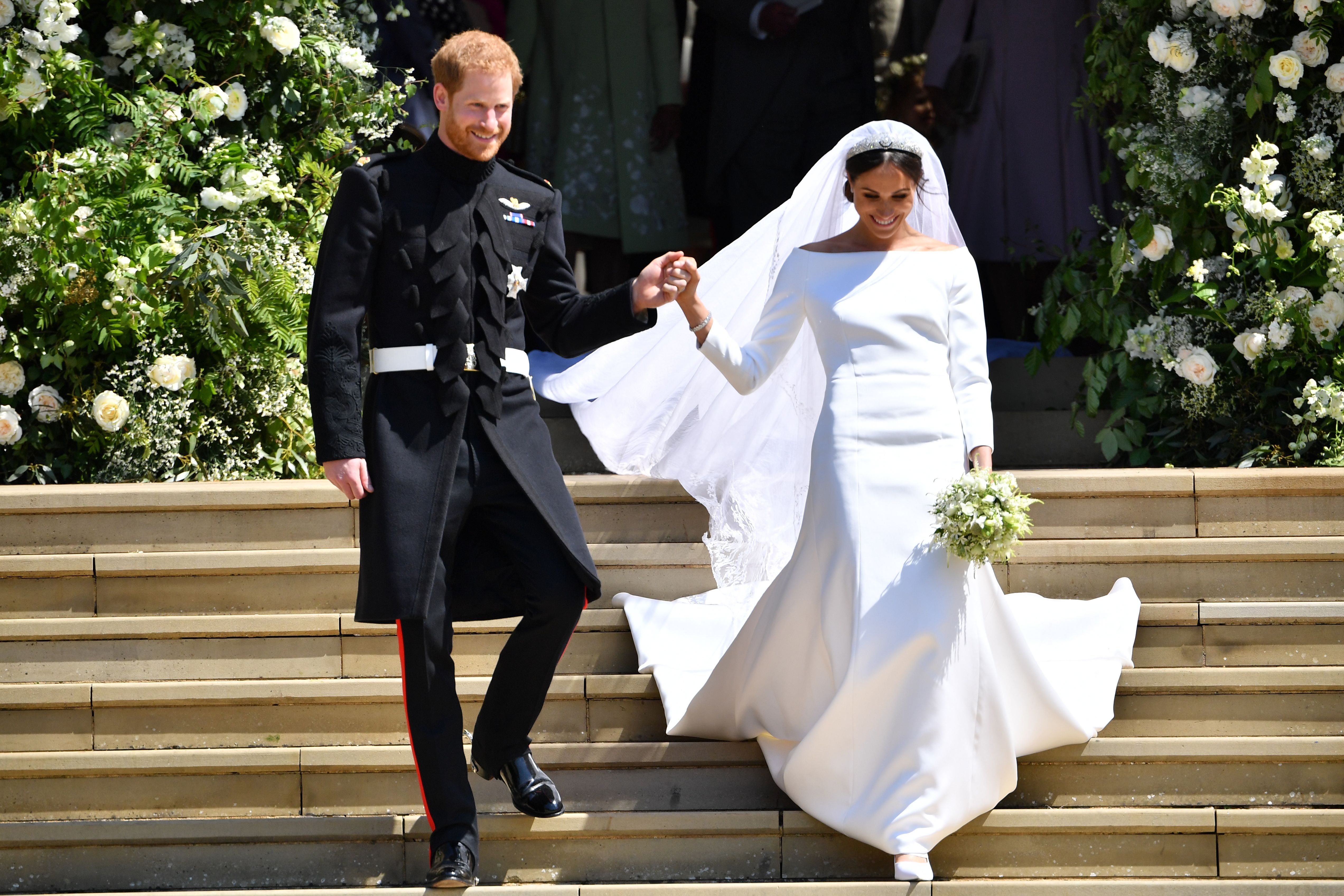 Britain's Prince Harry, Duke of Sussex and his wife Meghan, Duchess of Sussex emerge from the West Door of St George's Chapel, Windsor Castle