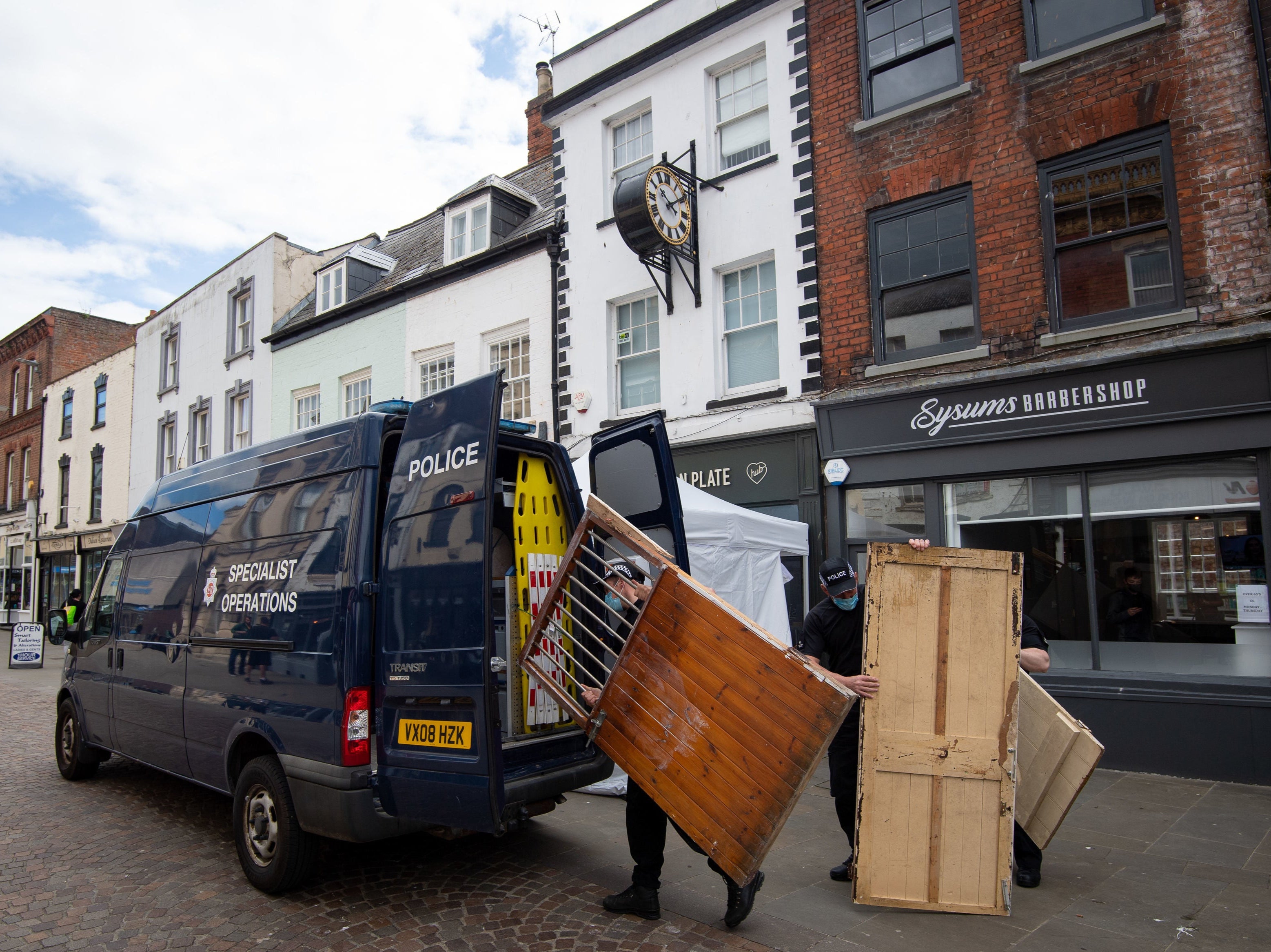 Police remove wooden doors from the Clean Plate cafe in Gloucester ahead of excavation works in the search for a suspected Fred West victim