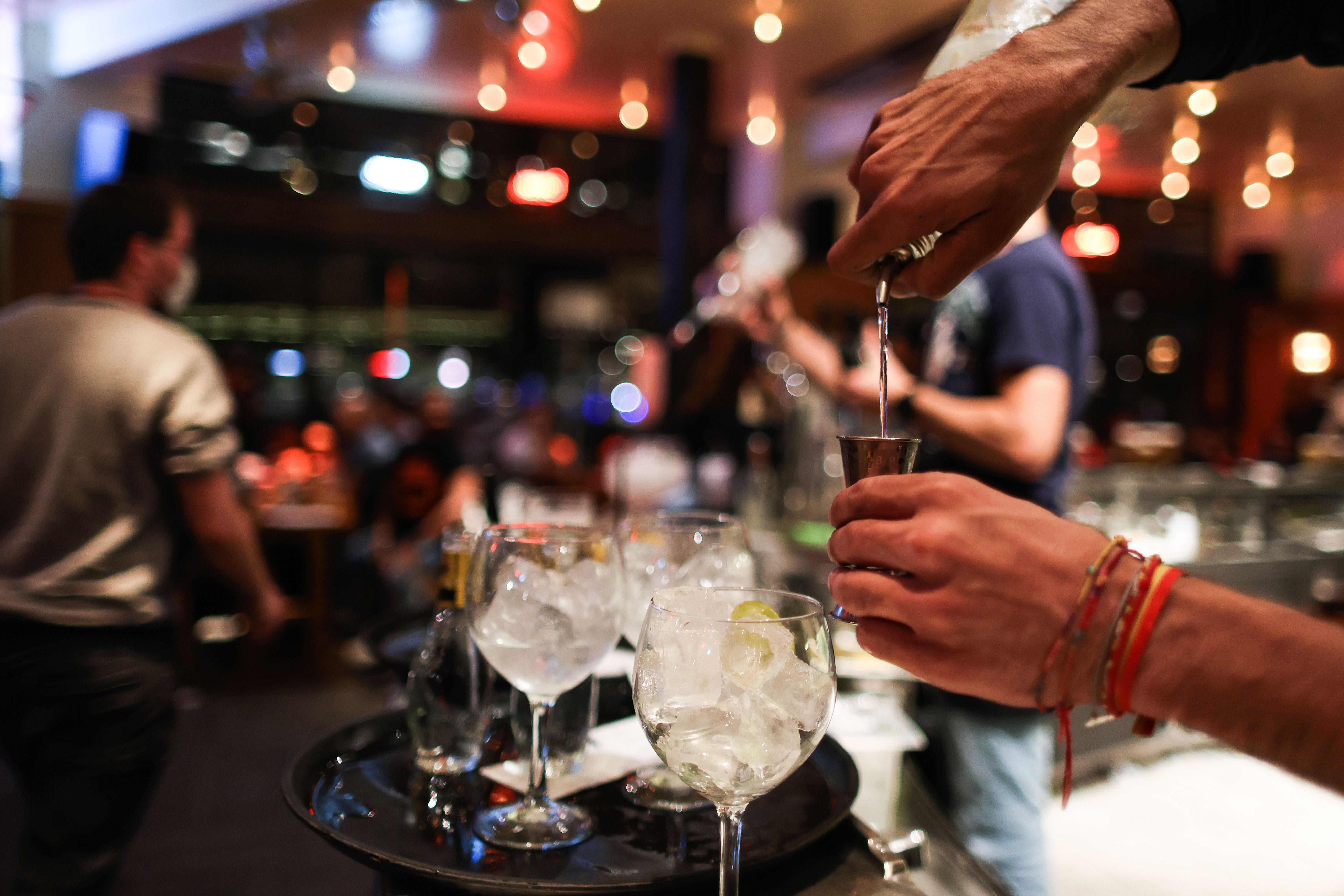 A waiter serves a cocktail at a bar on the eve of the mandatory closure of bars in Brussels