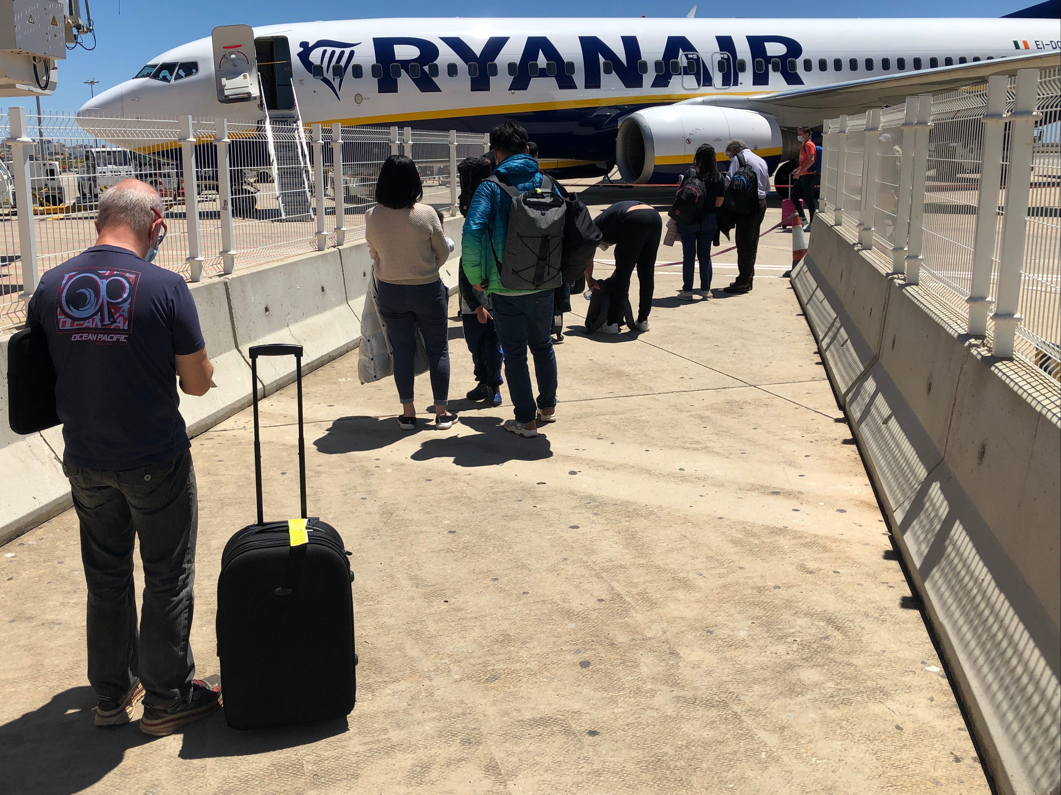 Waiting game: passengers at Faro airport queuing for a flight to London Stansted