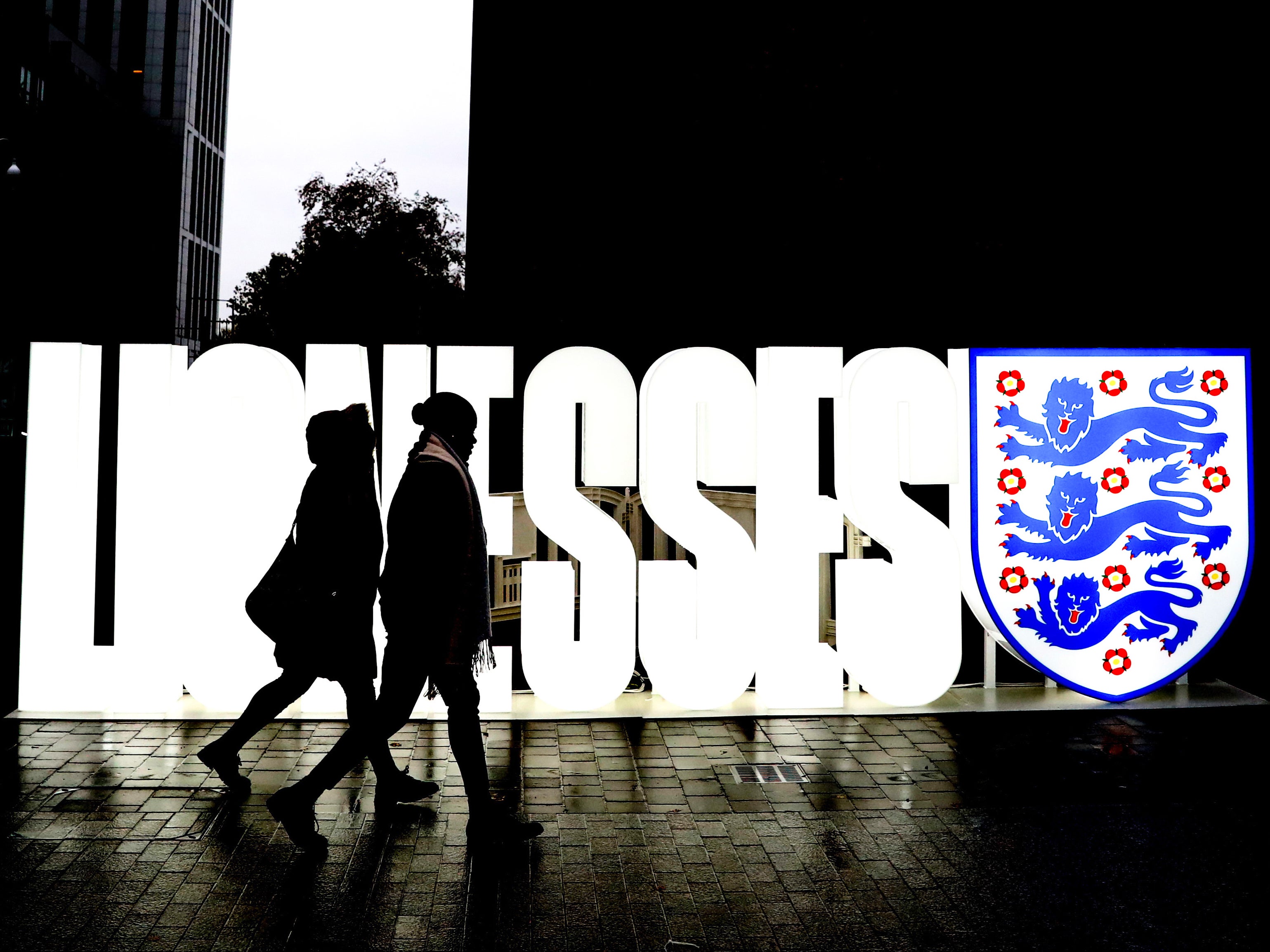 Fans make their way past an England Lionesses sign