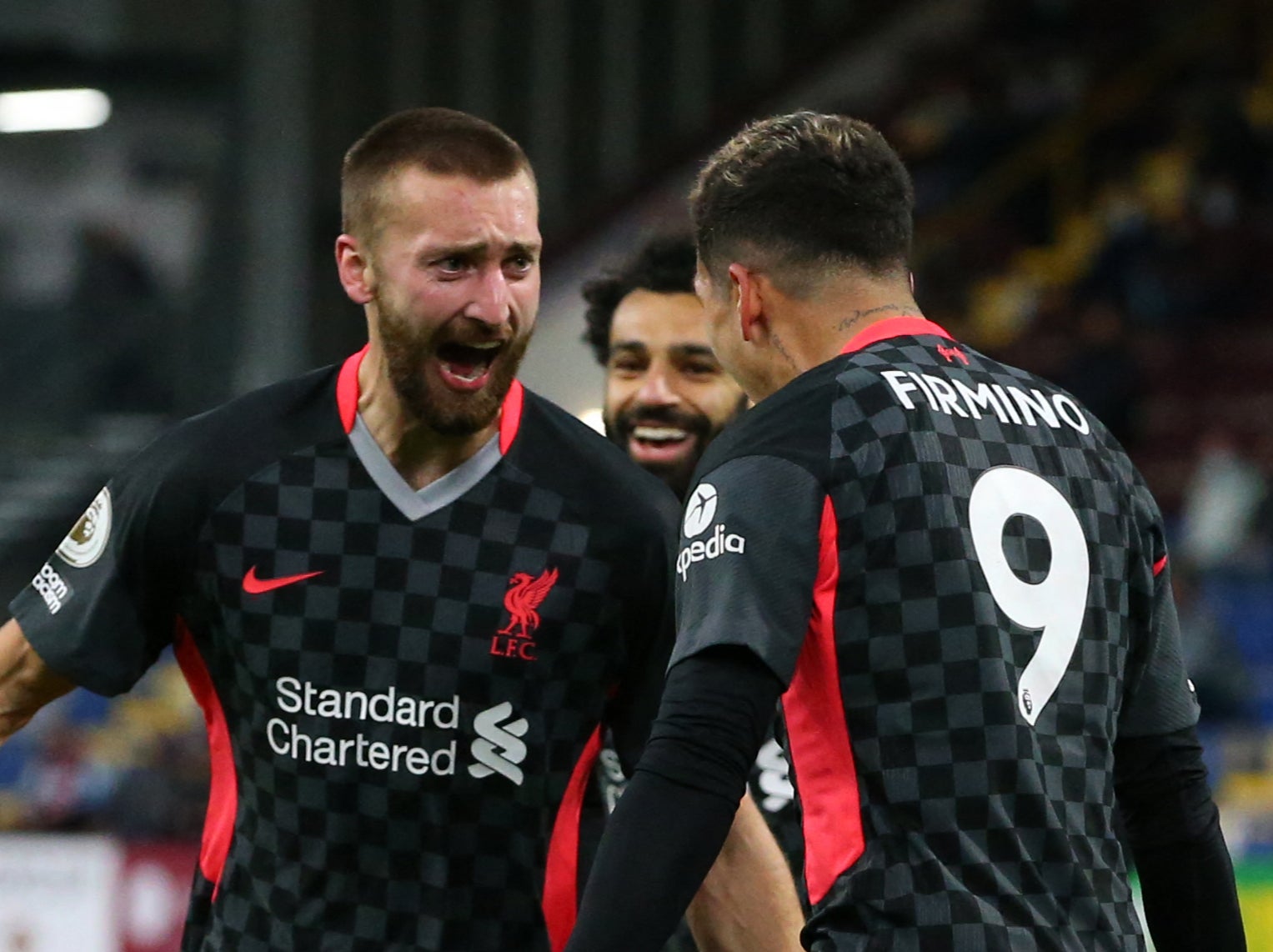 Liverpool goalscorers Nat Phillips and Roberto Firmino celebrate together