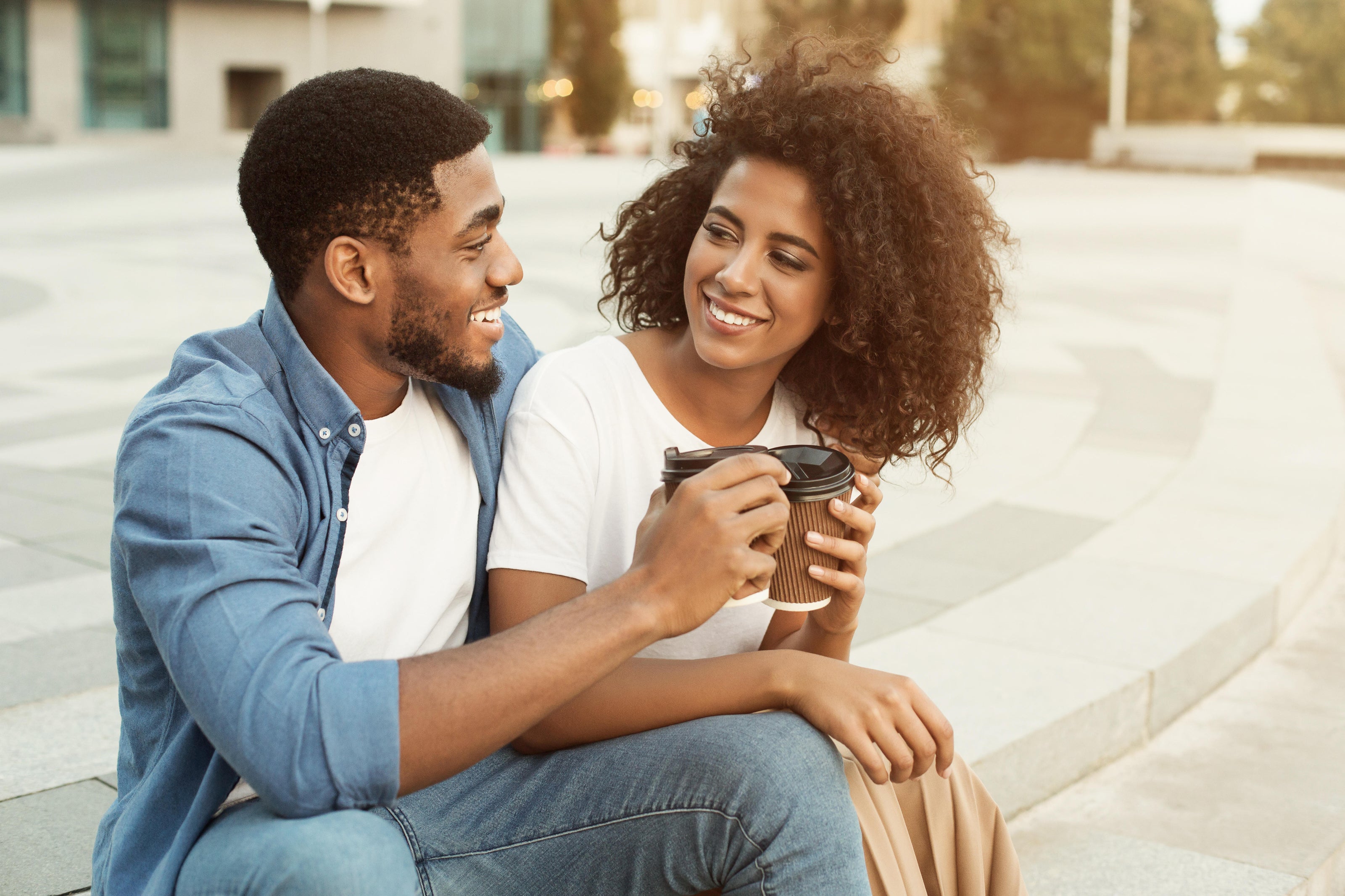 Loving couple relaxing with cup of coffee