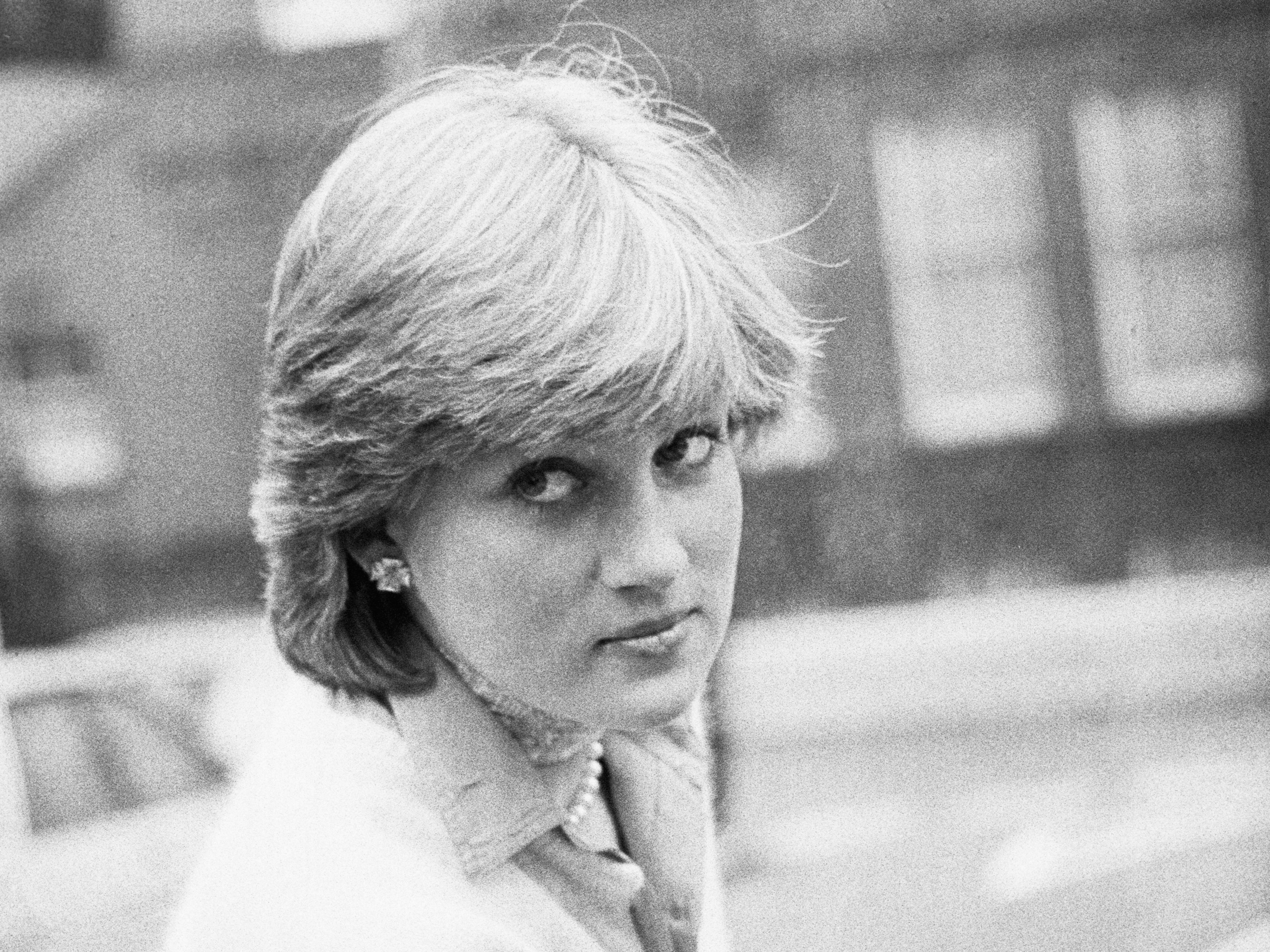 Lady Diana Spencer opens a car door as she holds her coat, London, UK, 13th November 1980.