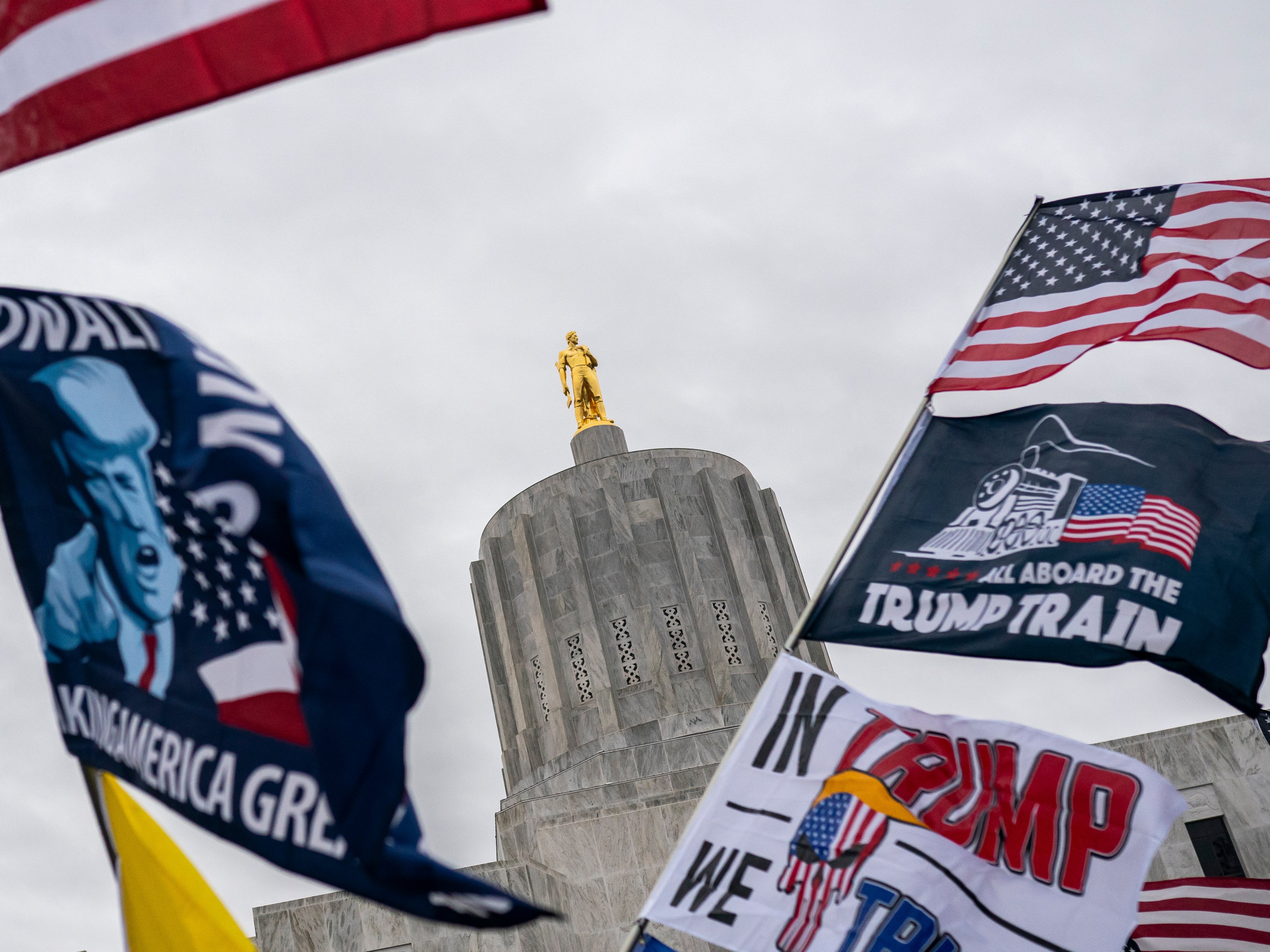 Protesters wave flags during a Defeat the Steal rally on November 14, 2020 in Salem, Oregon