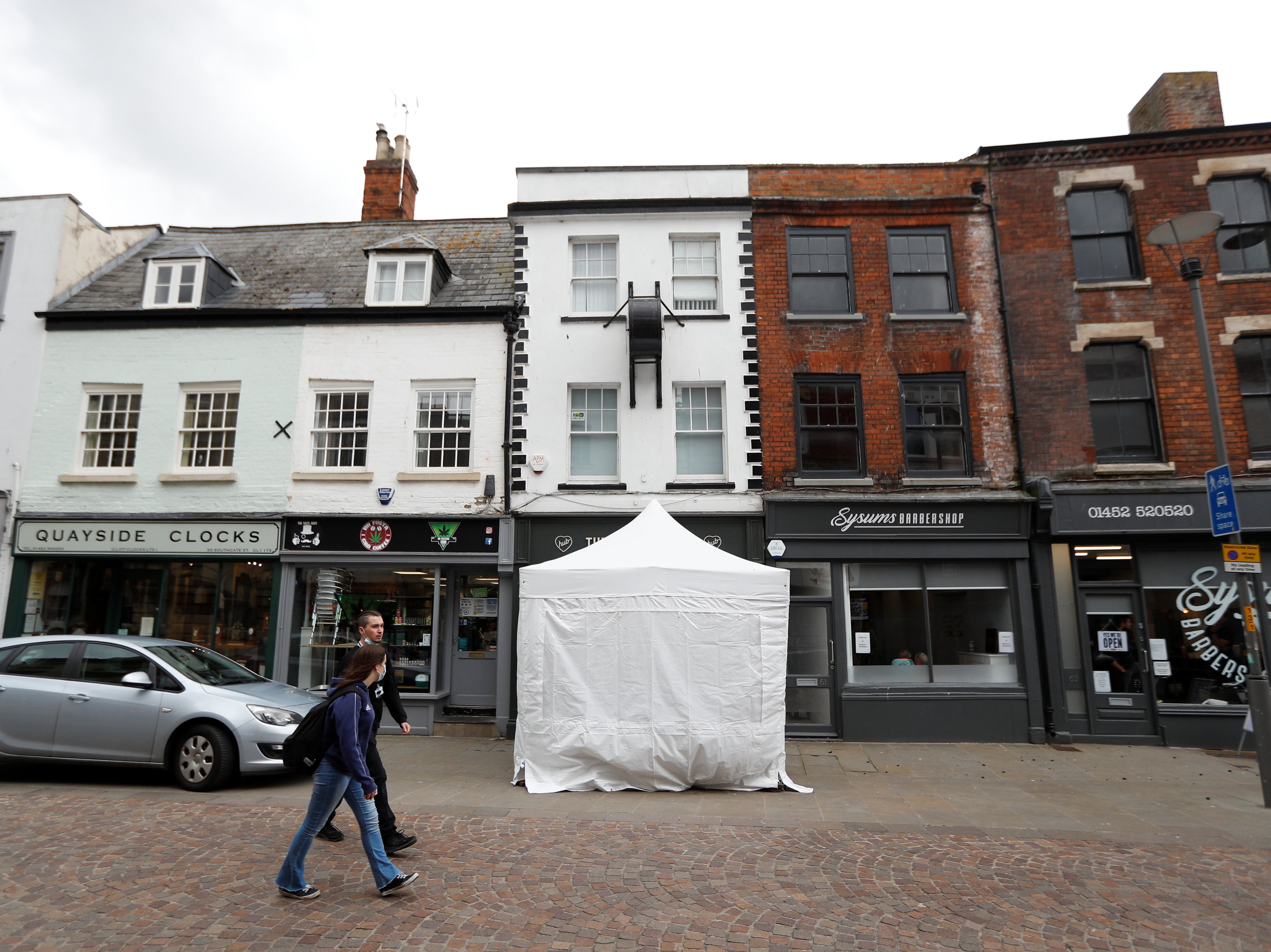 A police tent covers the entrance to The Clean Plate cafe in Gloucester where investigators are excavating the cellar