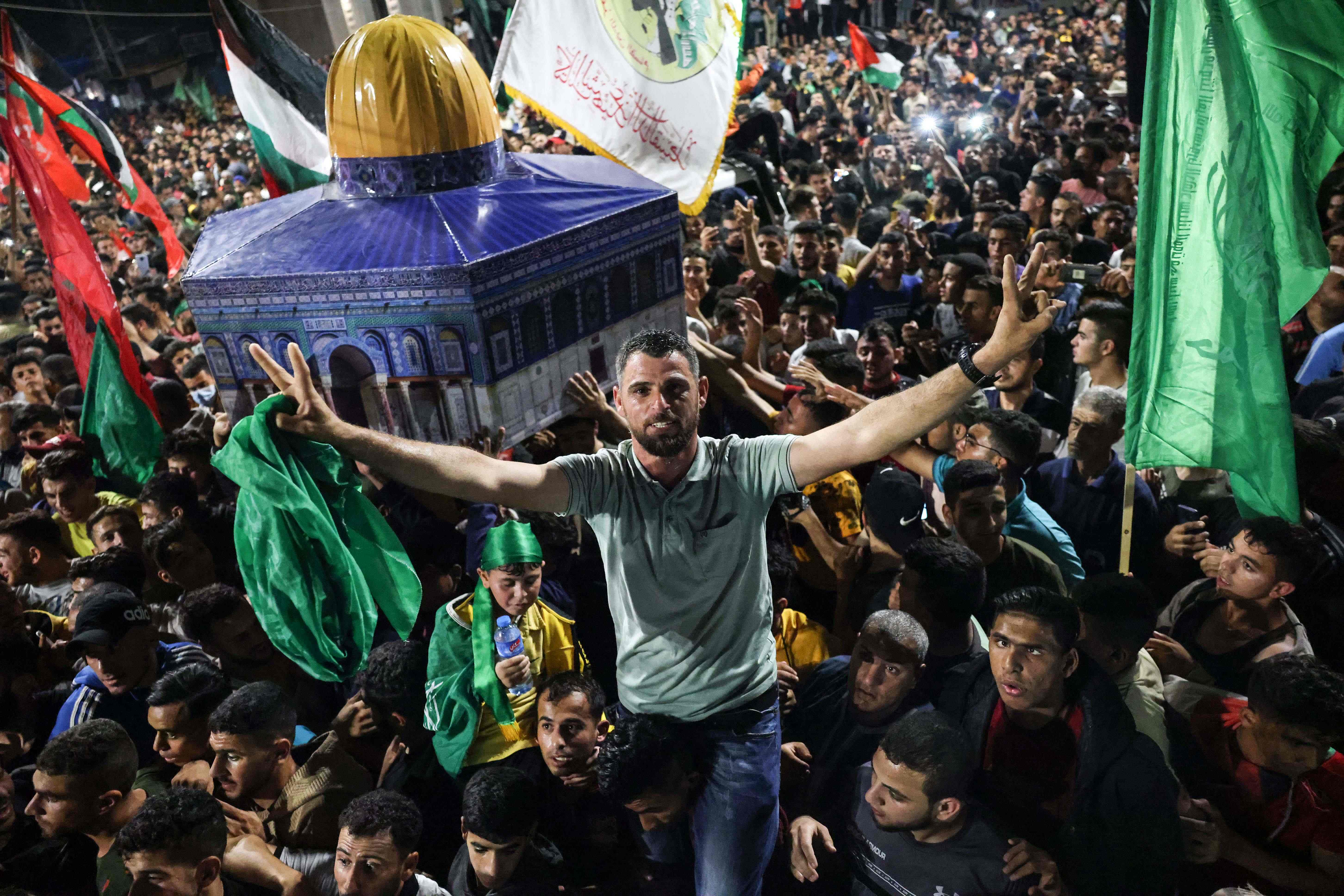 People celebrate the ceasefire in Khan Yunis, in the southern Gaza Strip