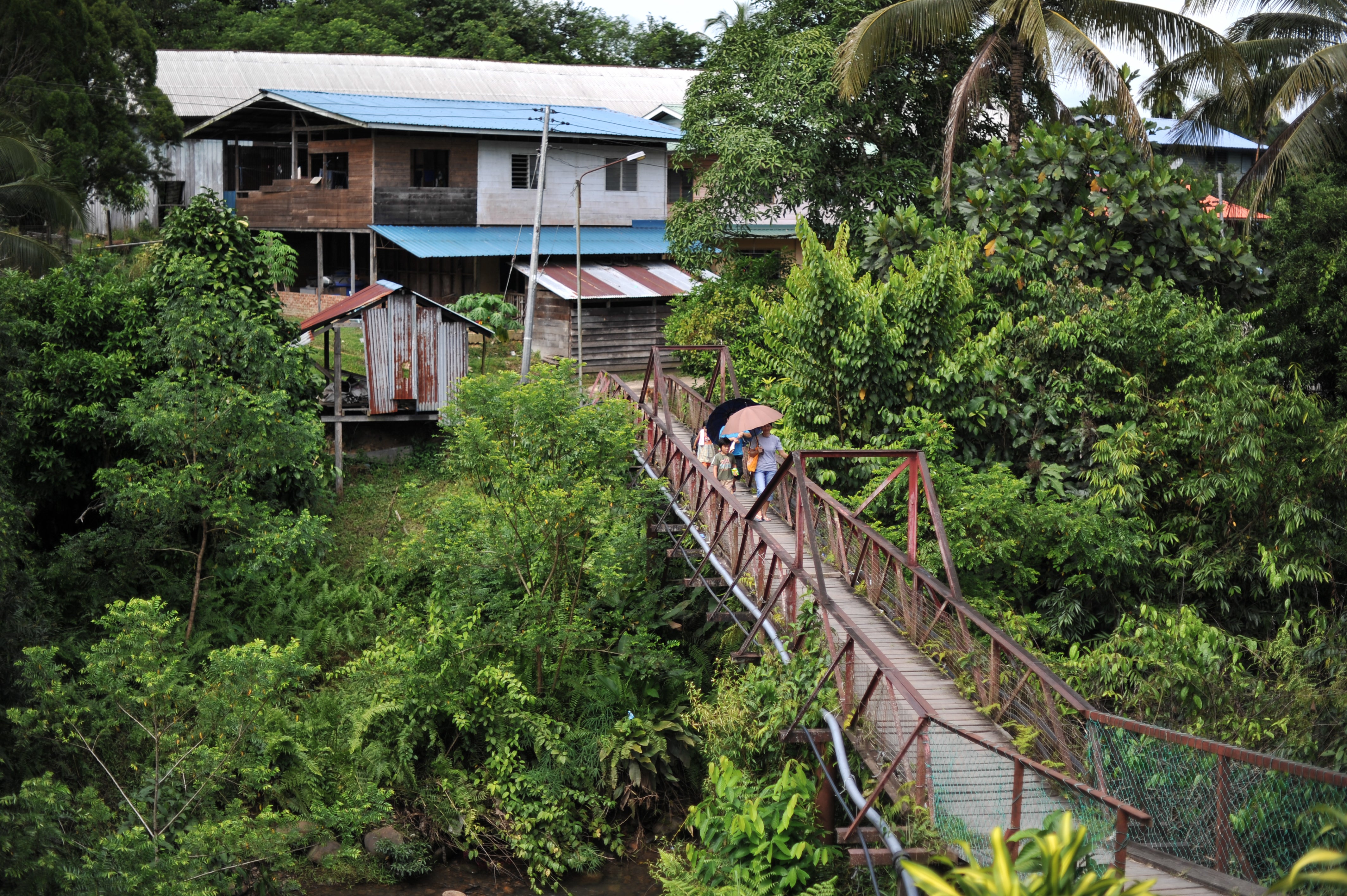 File image: Villagers walk on a bridge in Malaysia’s Sarawak state on Borneo island