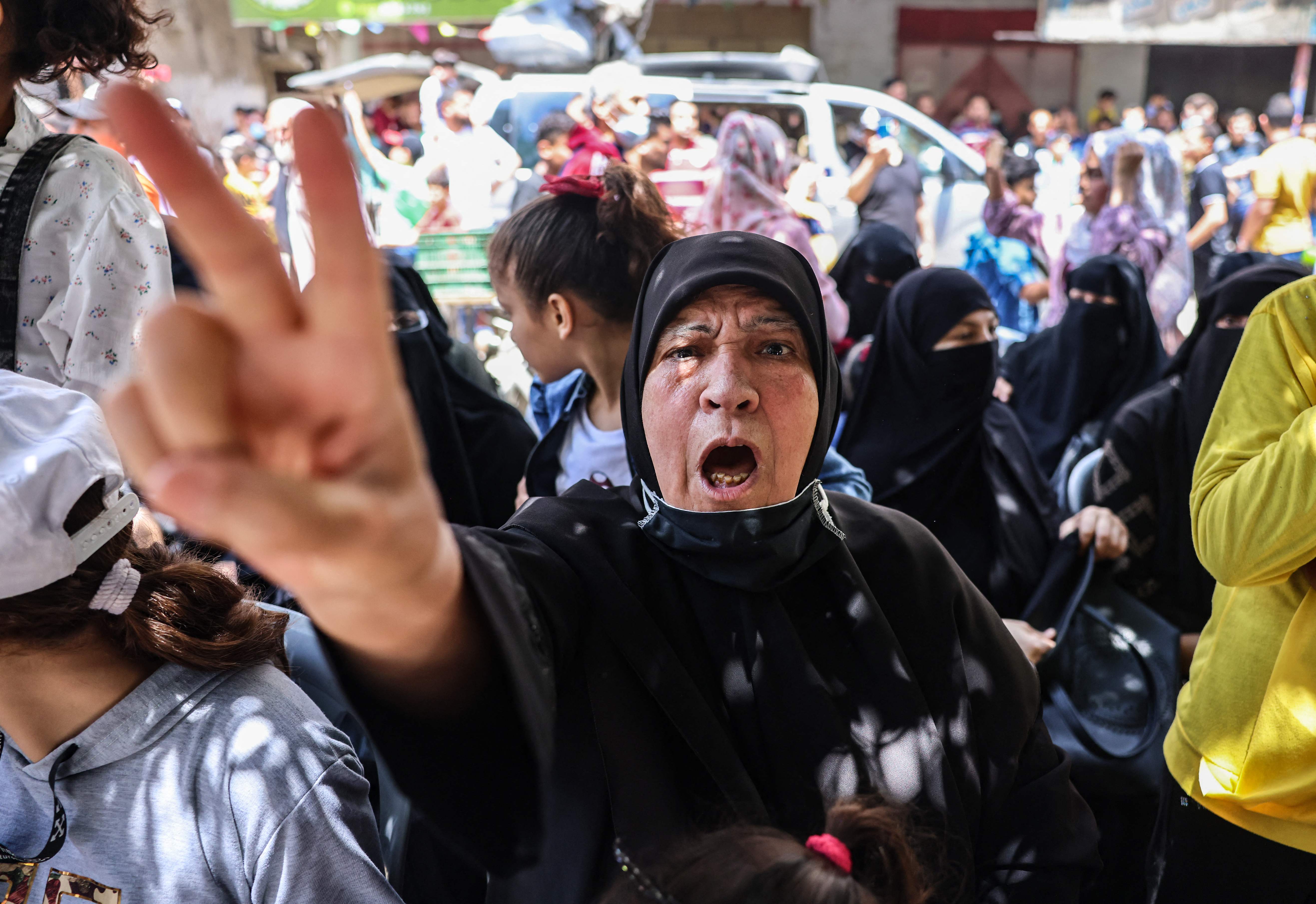 Palestinians celebrate in Khan Younis, in the southern Gaza Strip, after a ceasefire was brokered by Egypt between Hamas and Israel