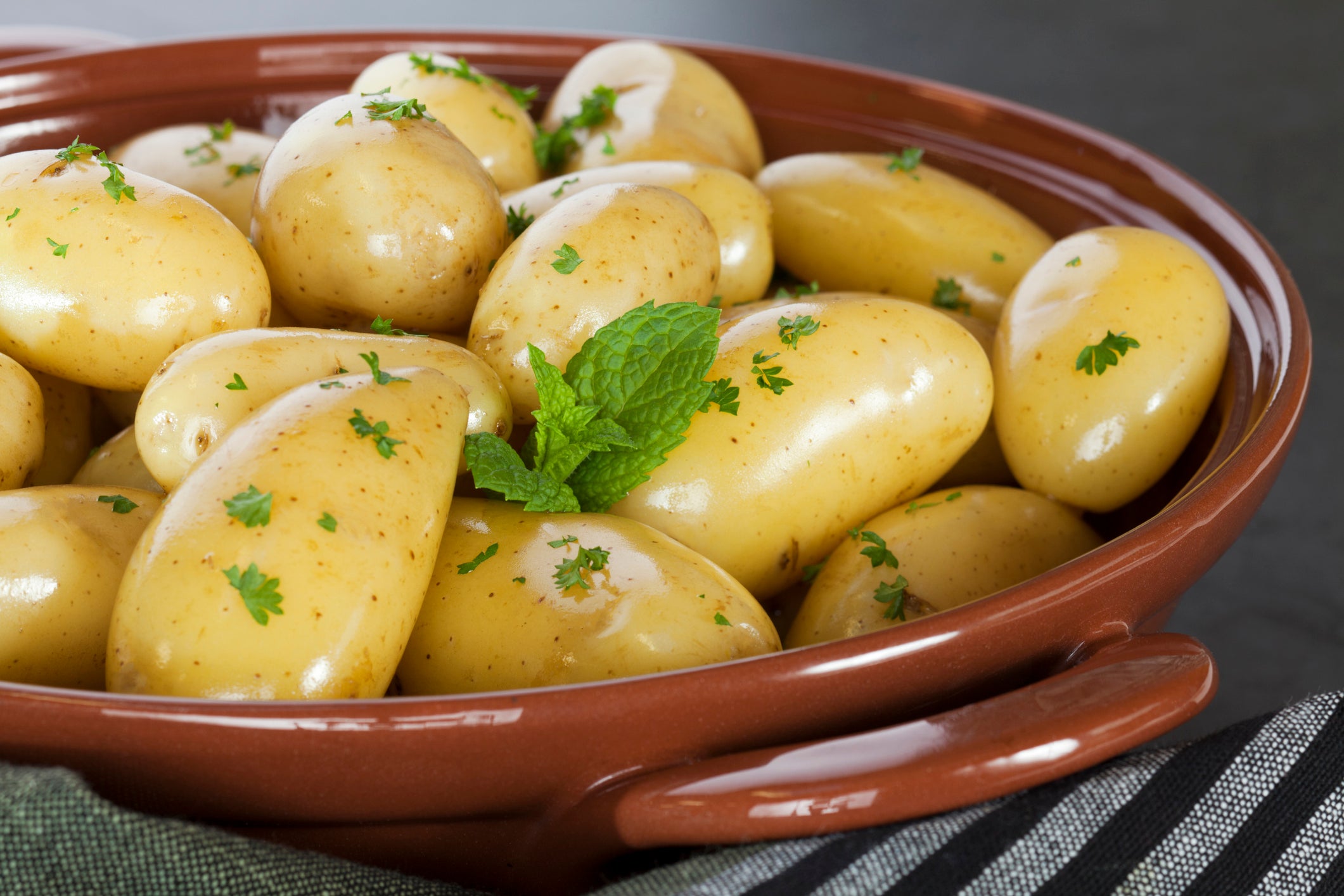 New Potatoes Steamed new potatoes in their skins with extra virgin olive oil, parsley and mint.