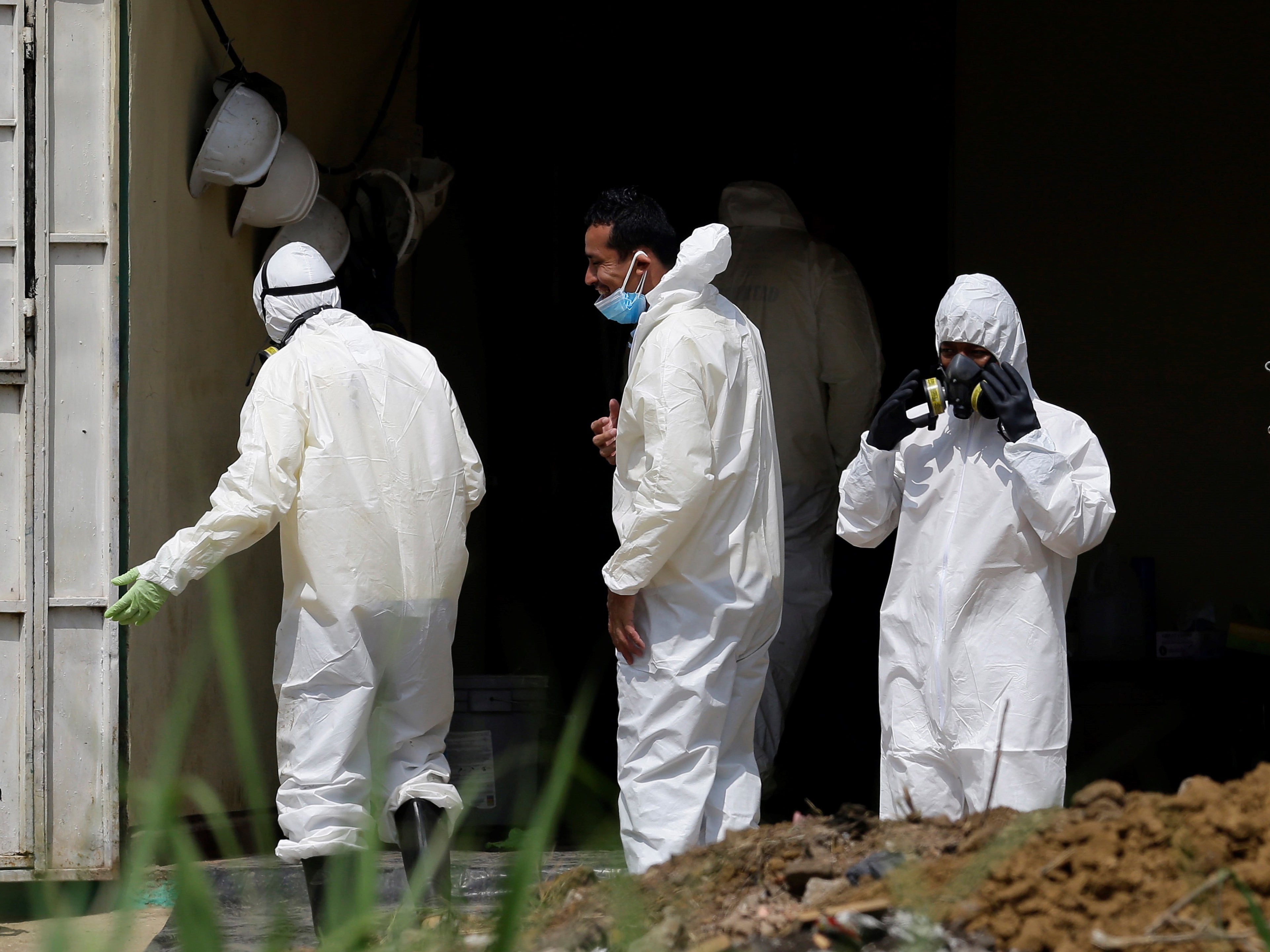 Forensic teams, members of the Attorney General’s Office, and police officers work during a search for human remains at the house of former police officer Hugo Ernesto Osorio.