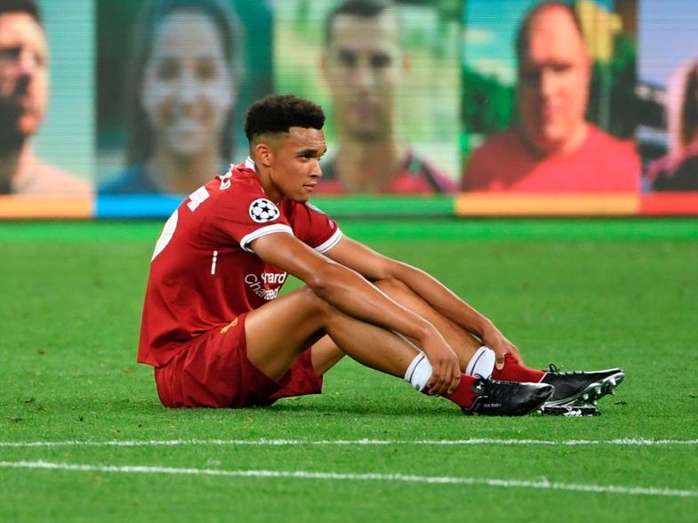 Trent Alexander-Arnold sits on the turf after Liverpool’s Champions League final defeat in 2018