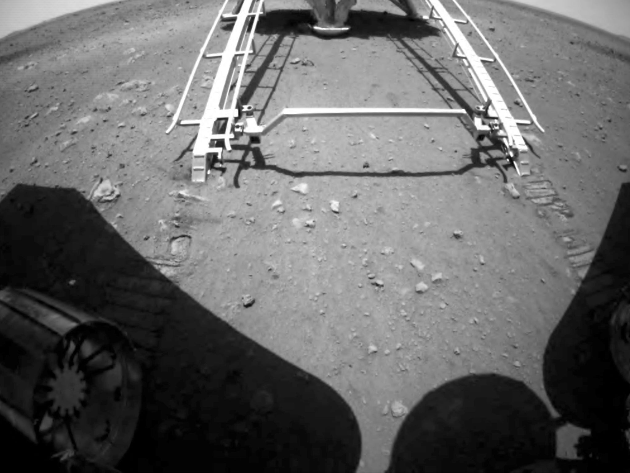 Zhurong drives down the ramp of the lander onto the surface of Mars, in an image released by the China National Space Administration