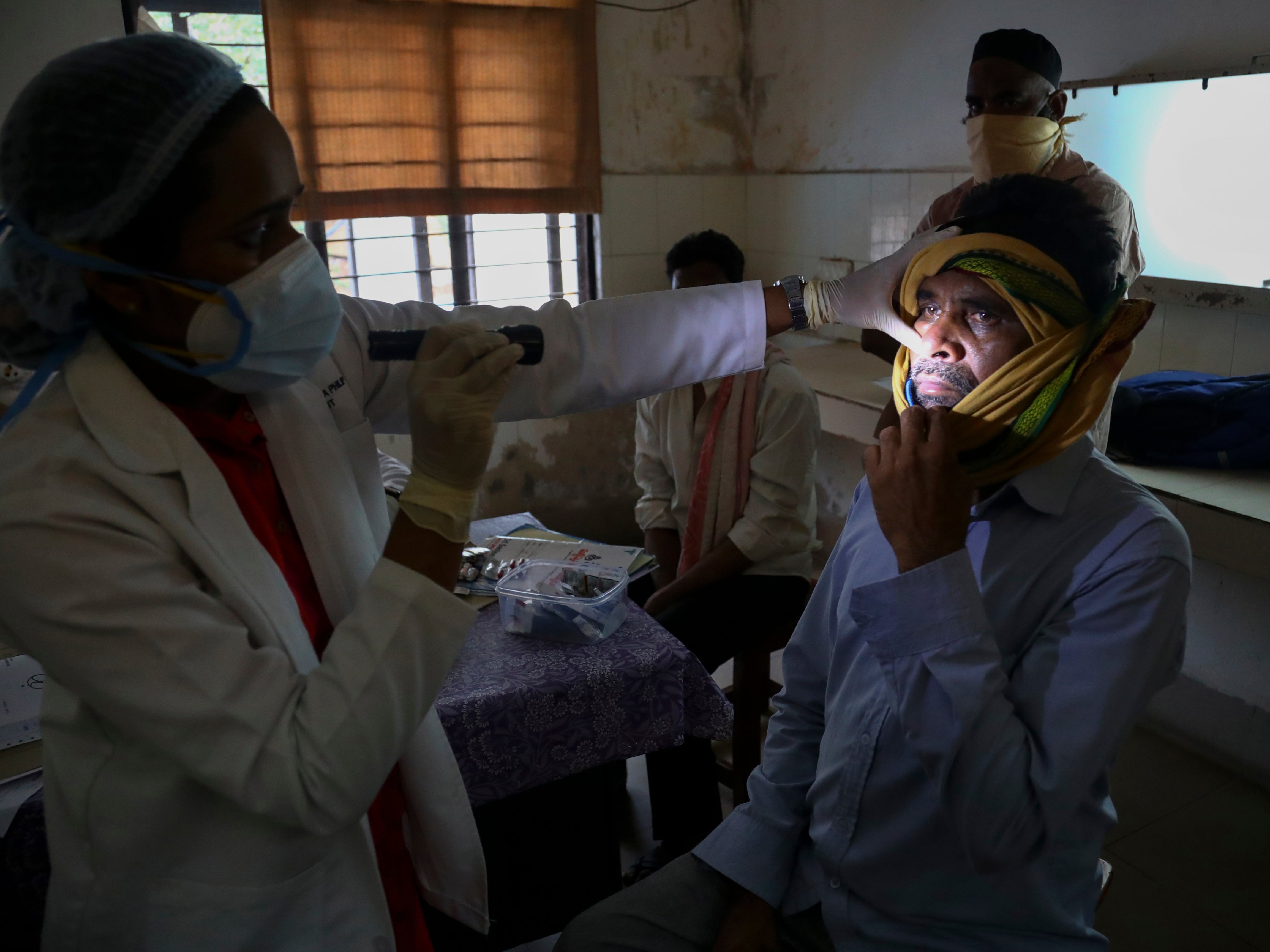 A doctor checks a man who recovered from Covid-19 and is now infected with black fungus at the Mucormycosis ward of a hospital in Hyderabad, India