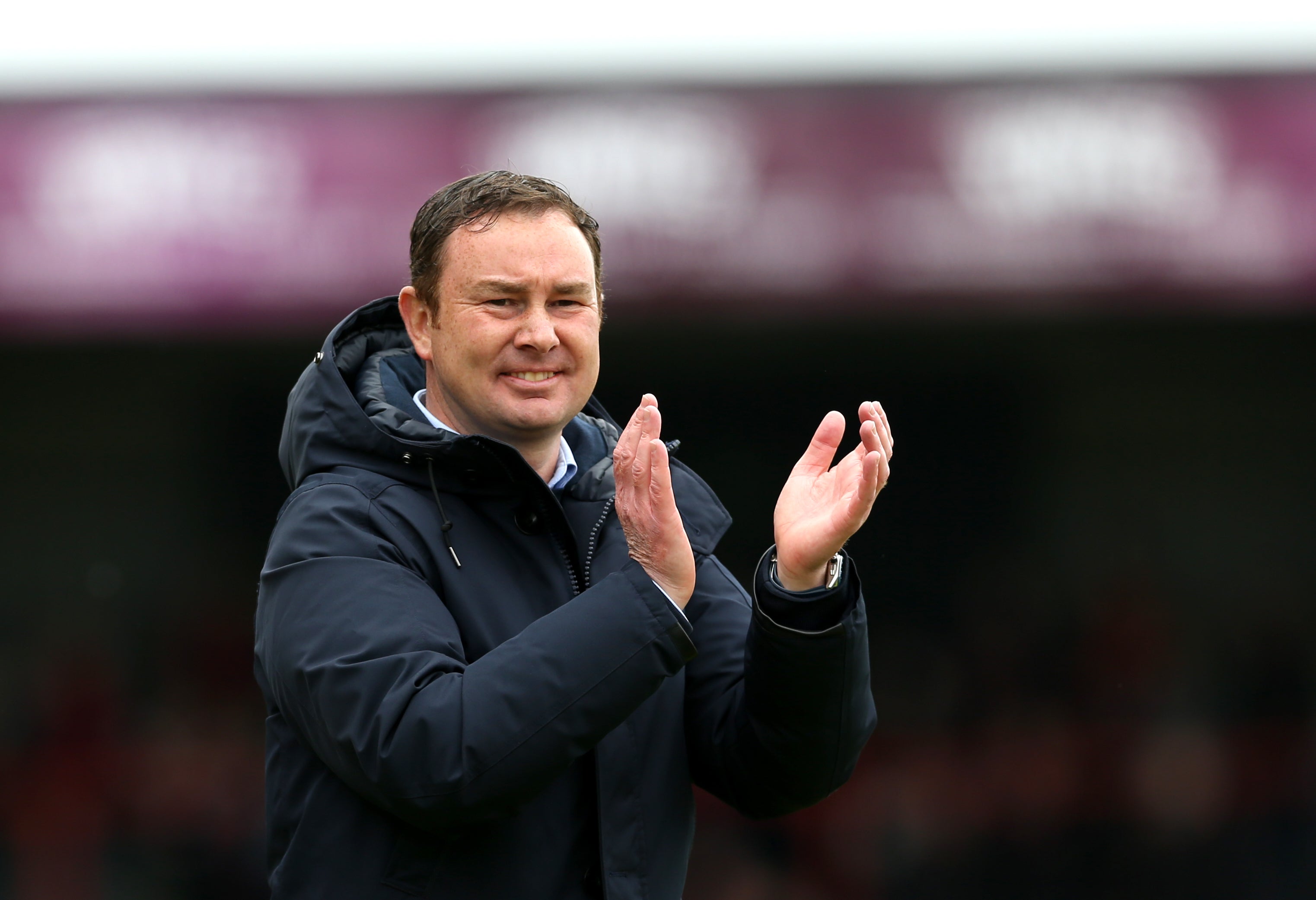 Morecambe manager Derek Adams applauds the fans after reaching the play-off final