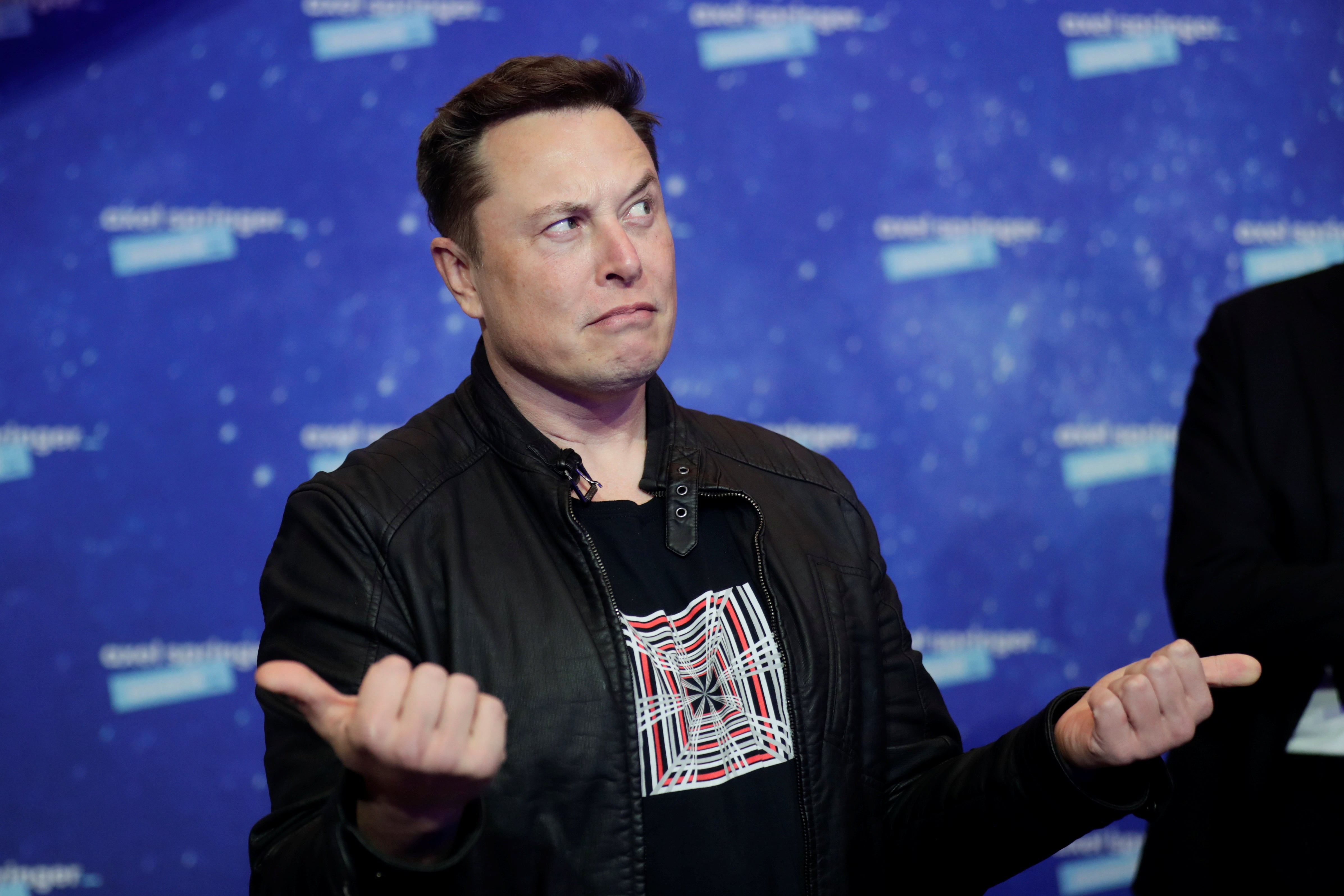 SpaceX owner and Tesla CEO Elon Musk gestures as he arrives on the red carpet for the Axel Springer Awards ceremony, in Berlin