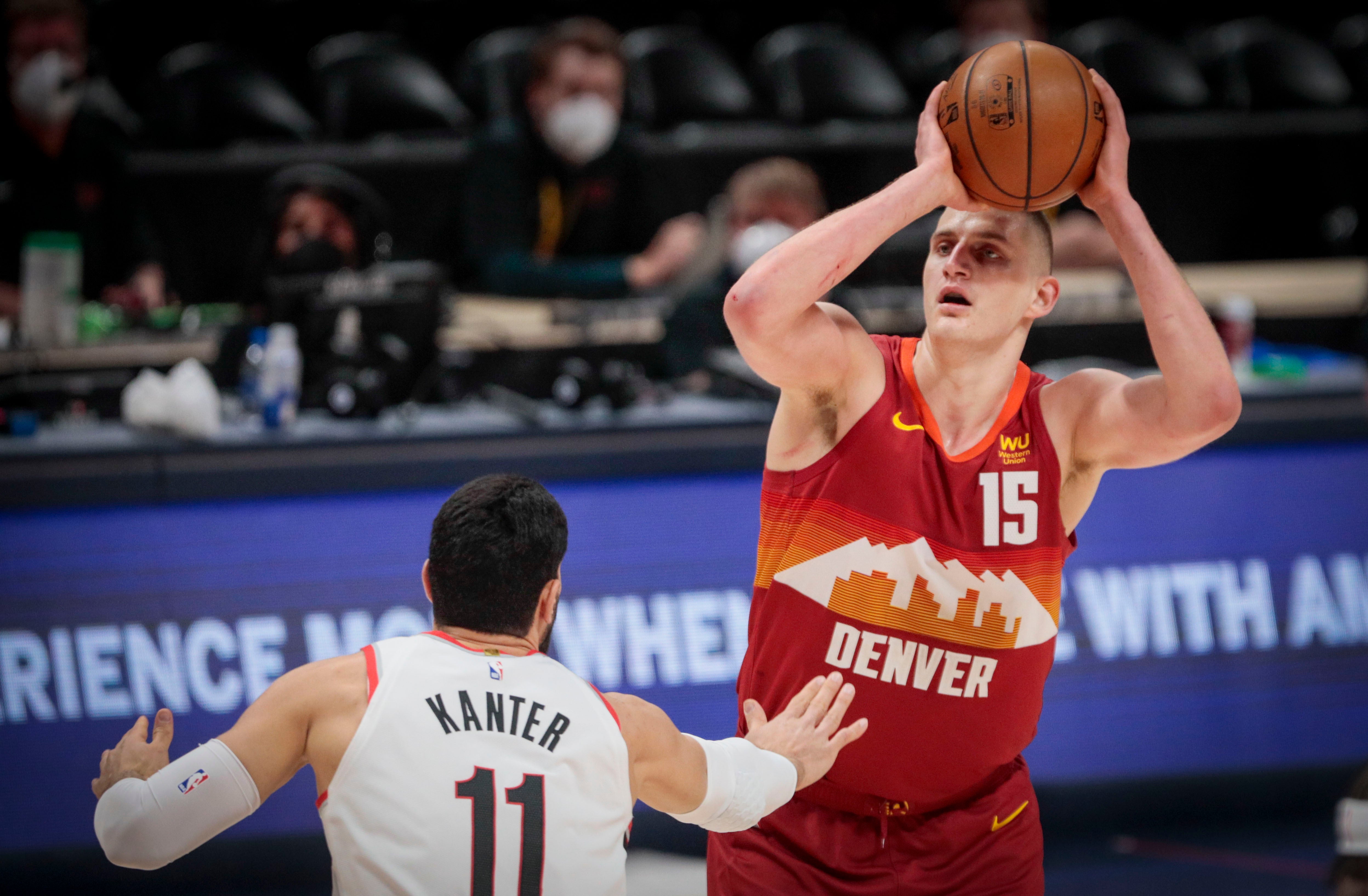 Denver Nuggets center Nikola Jokic (15) shoots over Portland Trail Blazers center Enes Kanter (11)