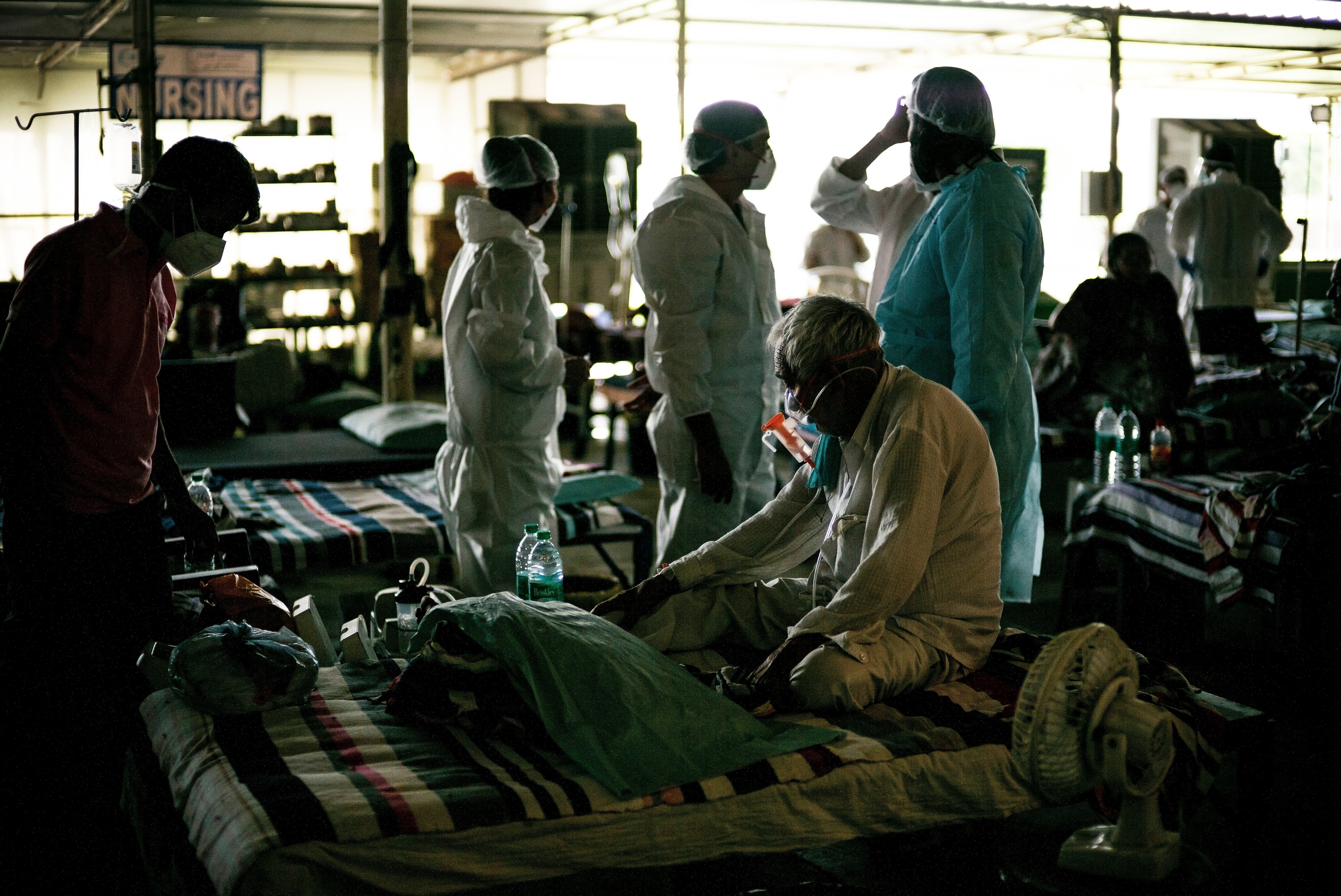 A man who is Covid-19 positive is given an Oxygen mask to aid his breathing