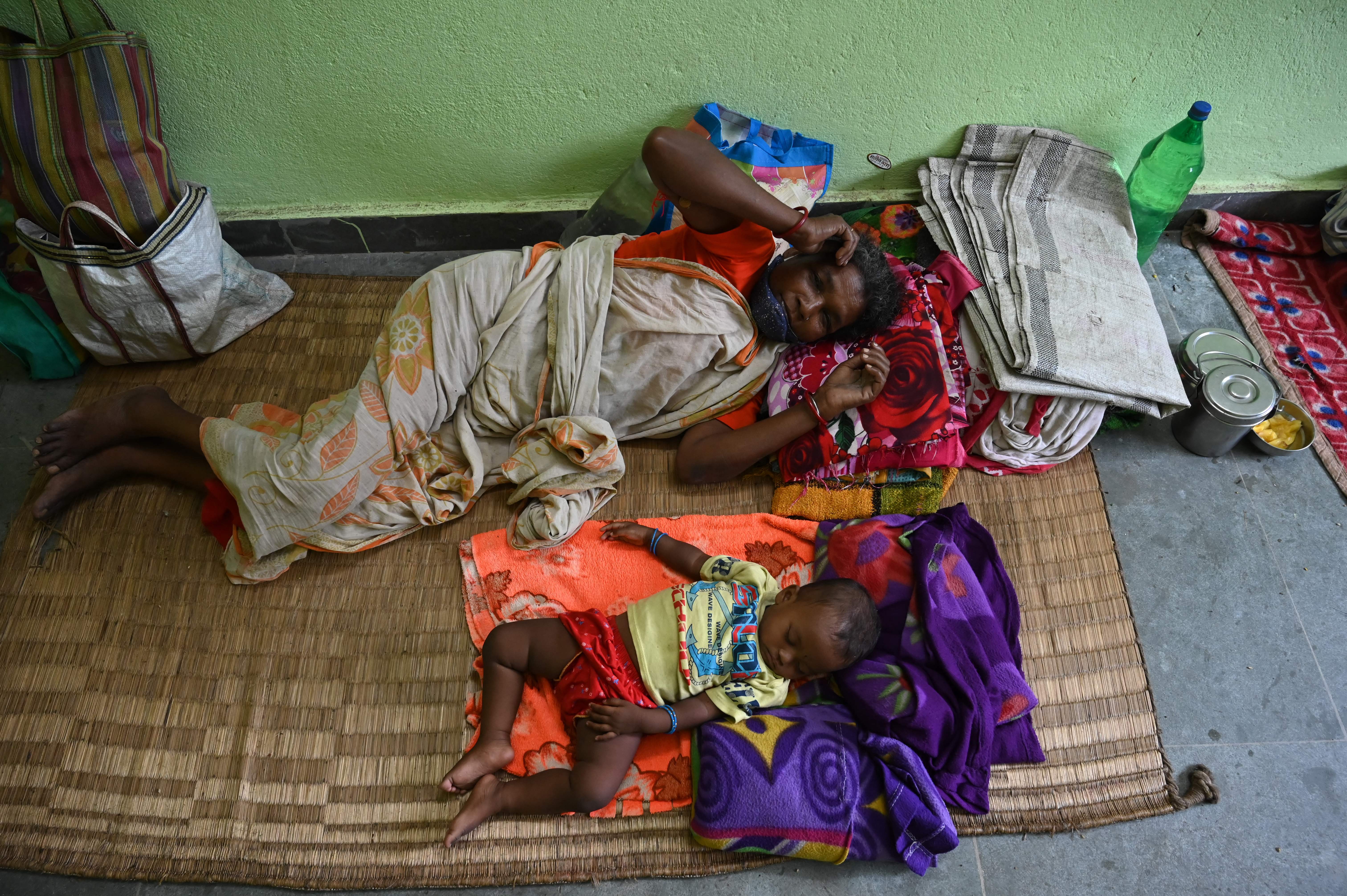 Villagers resting at a rescue shelter ahead of Cyclone Yaas making landfall