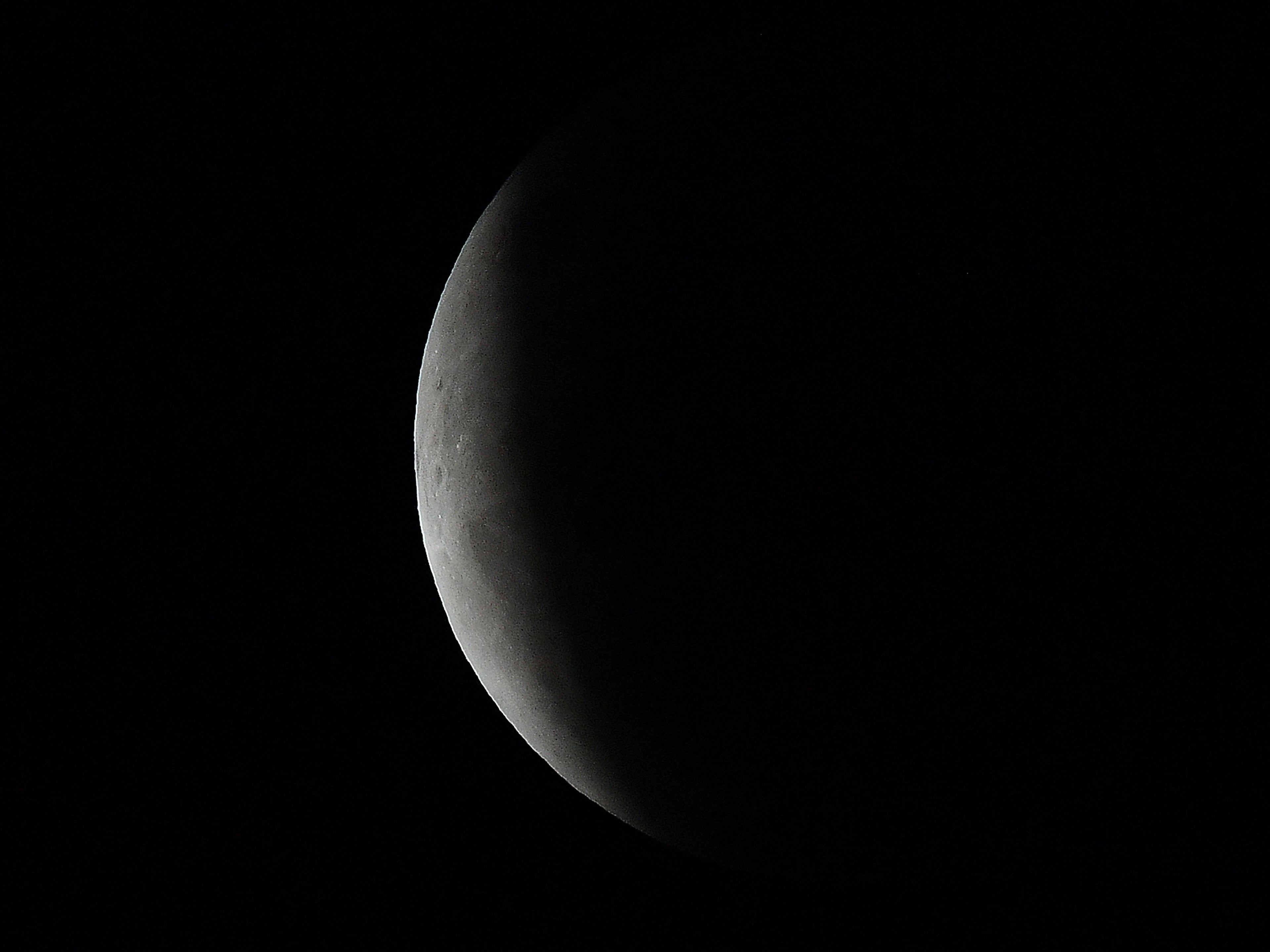 The full moon is seen during the partial eclipse in Sydney on Wednesday 26 May 2021 as stargazers across the Pacific cast their eyes skyward to witness a rare ‘Super Blood Moon’