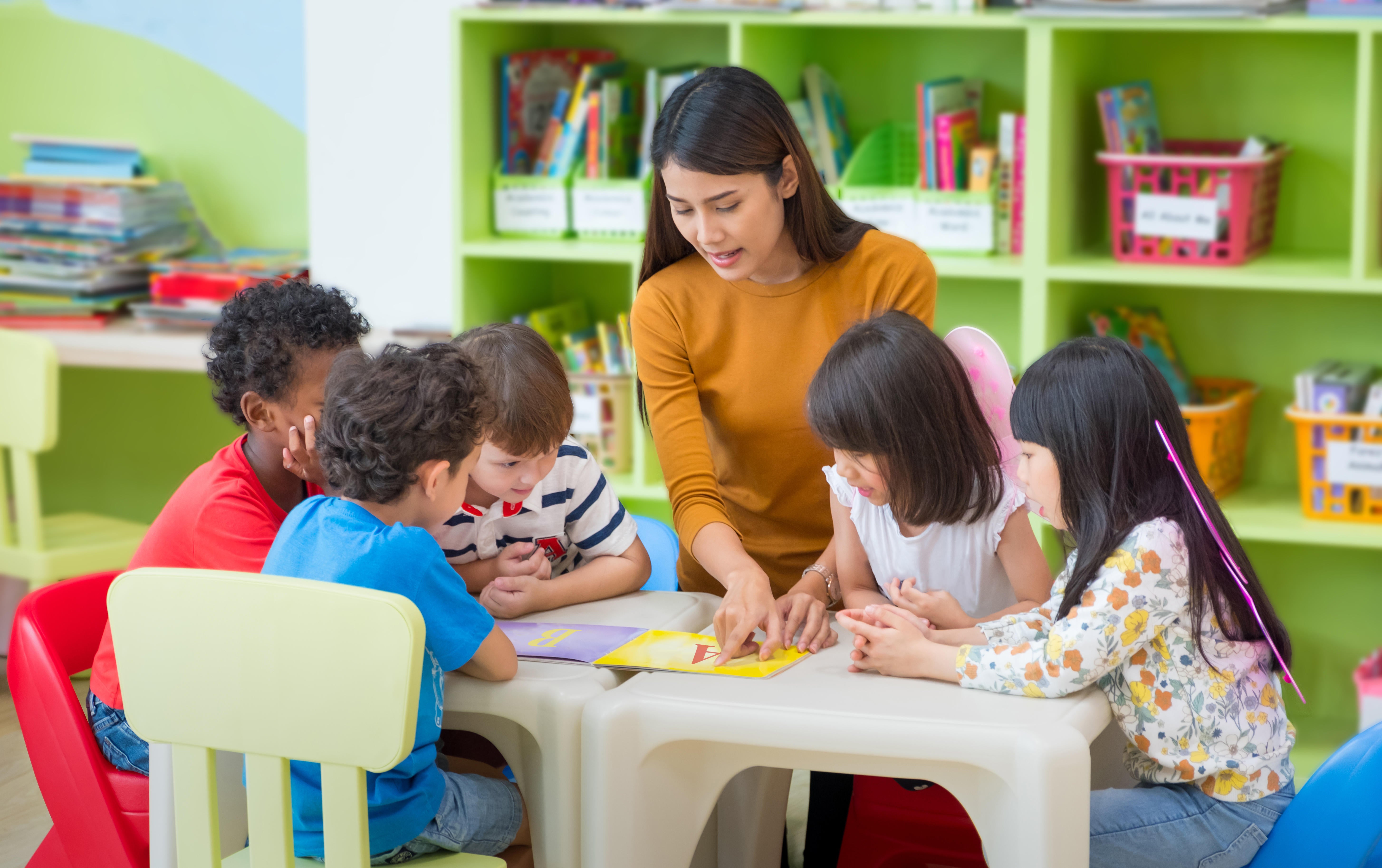 teacher reading to children in nursery school