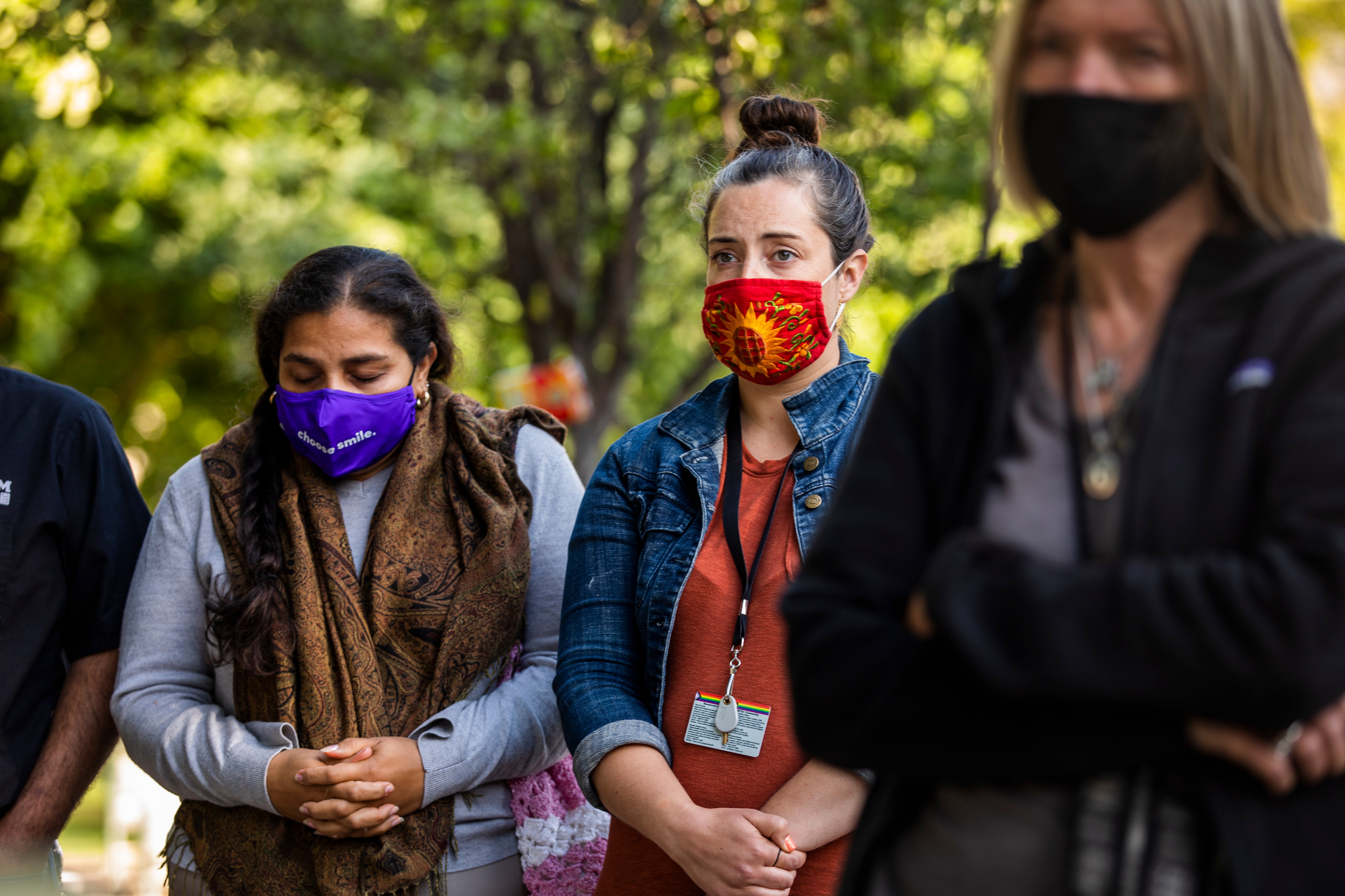 People take part in a vigil held by the Interfaith Community following the mass shooting at the Valley Transportation Authority (VTA) light-rail yard, at St. James Park