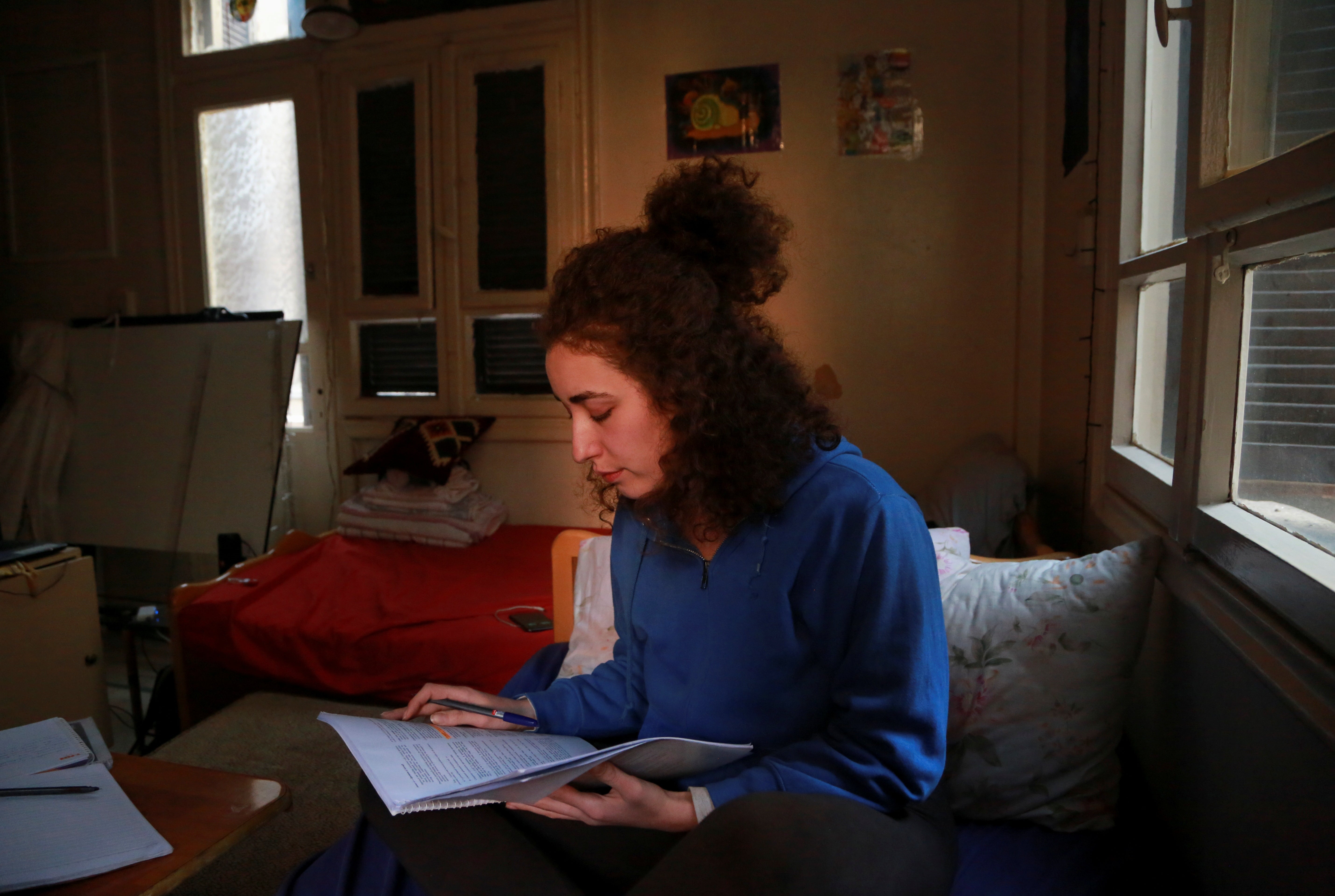 Ghenwa studies for exams in her room in Damascus