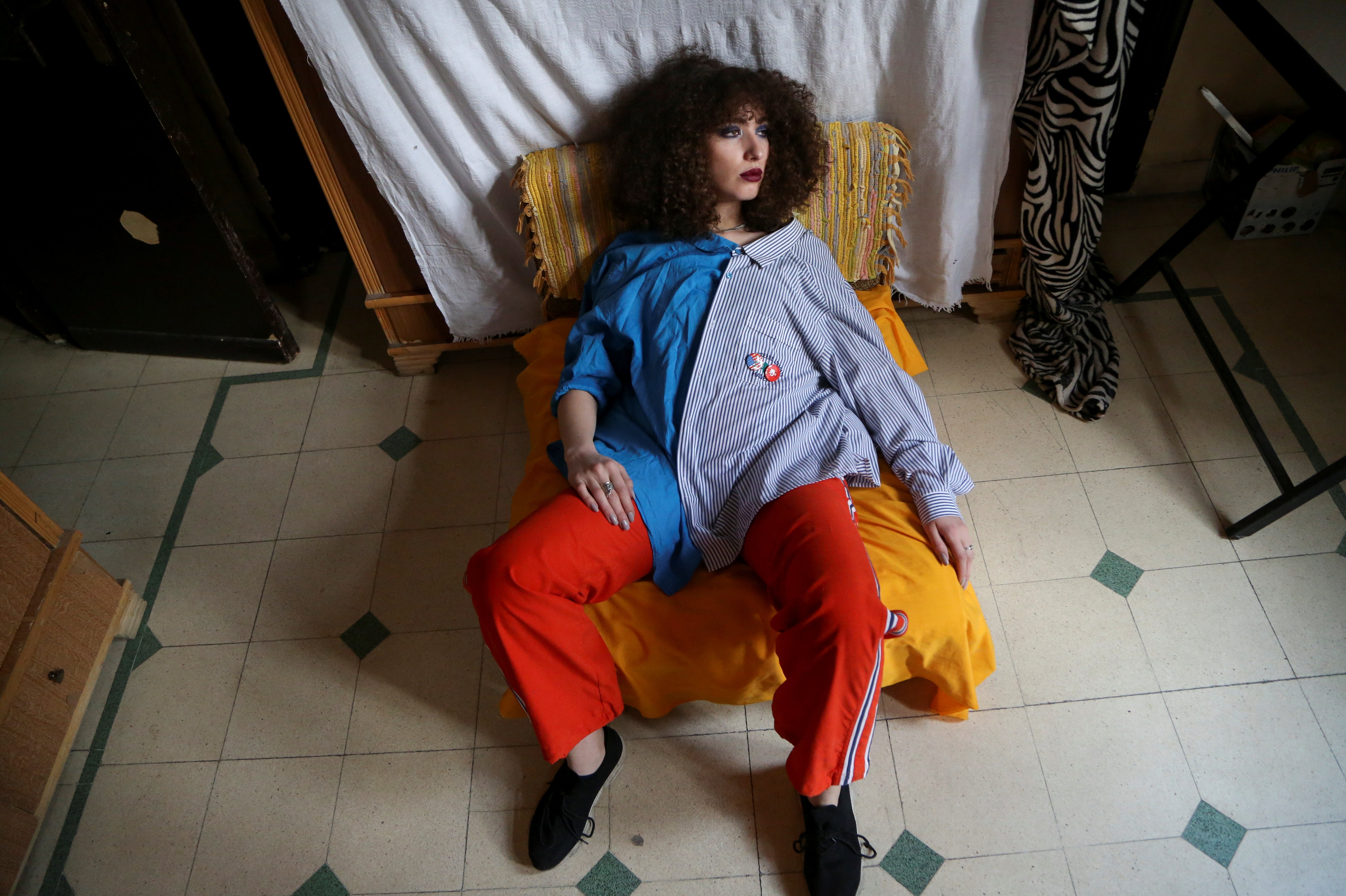 Ghenwa, 21, a trainee flight attendant, poses for a photograph in her room in Damascus, Syria. The freedom to travel was the main reason Ghenwa decided to train as an air hostess.