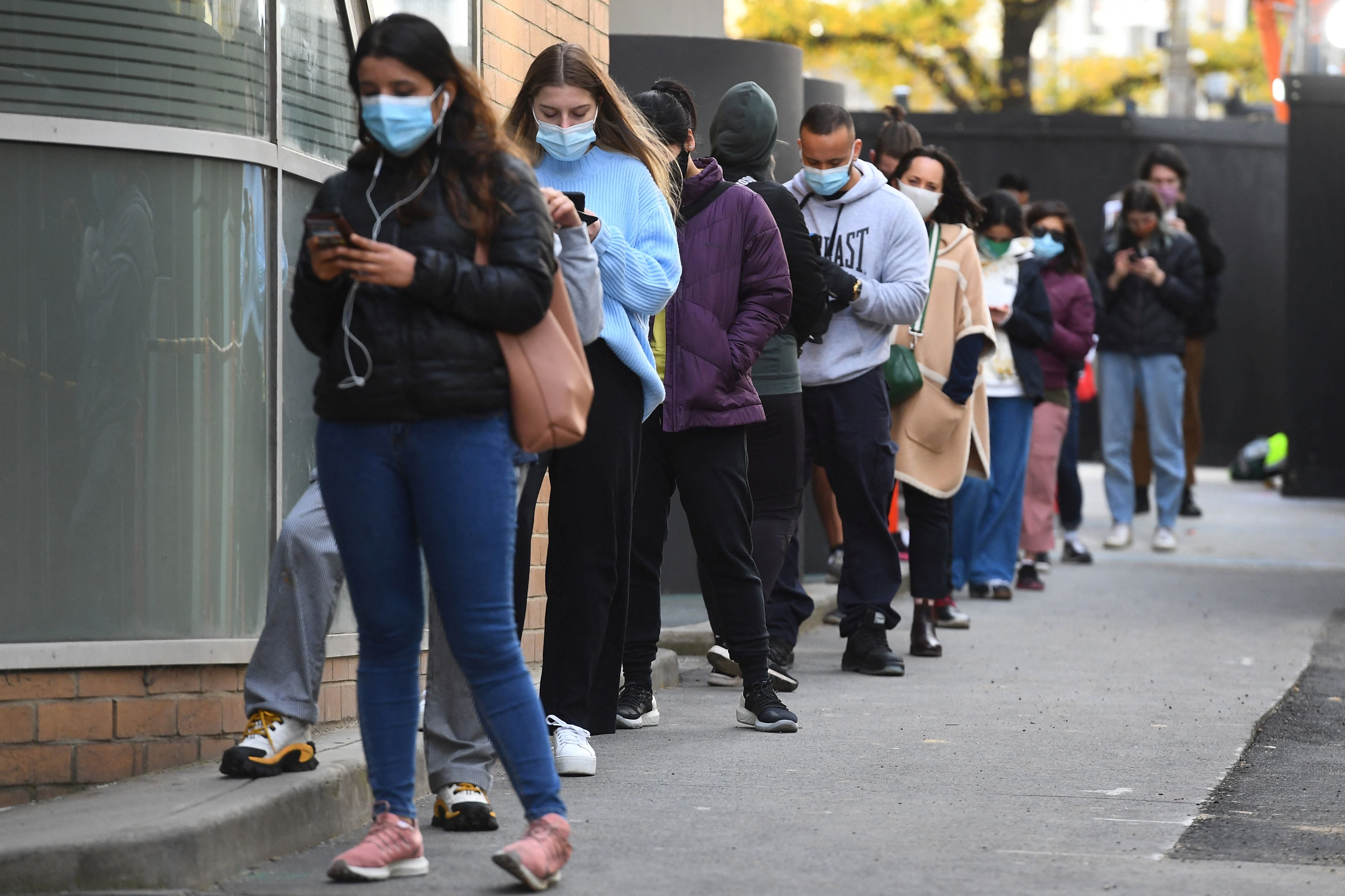 People queue for a Covid-19 test in Melbourne on 27 May, 2021 after five million people in Melbourne were ordered into a snap week-long lockdown