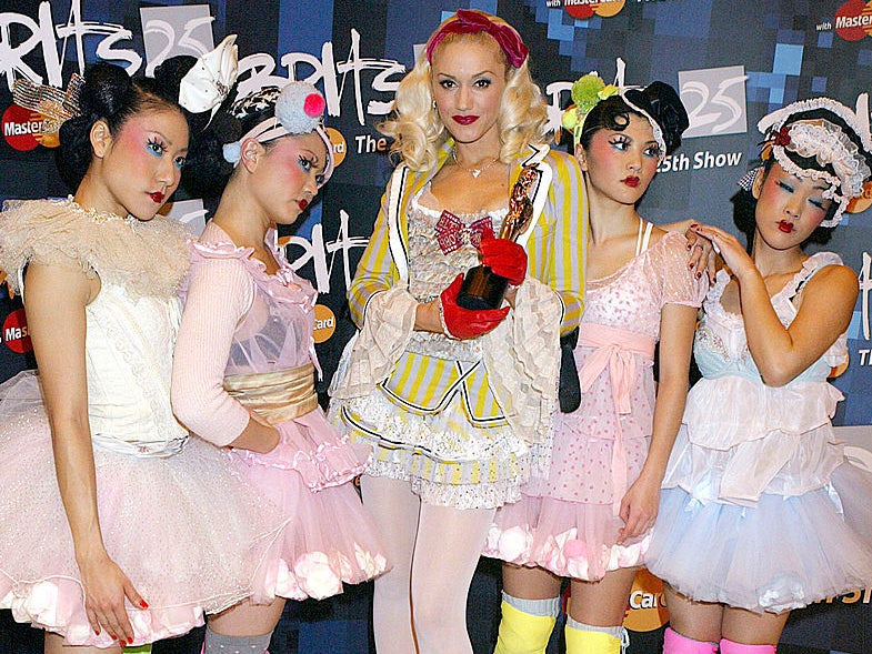 Singer Gwen Stefani with her award for Best International Female Solo Artist and dancers the Harajuku Girls pose in the Press Room during the 25th Anniversary BRIT Awards 2005