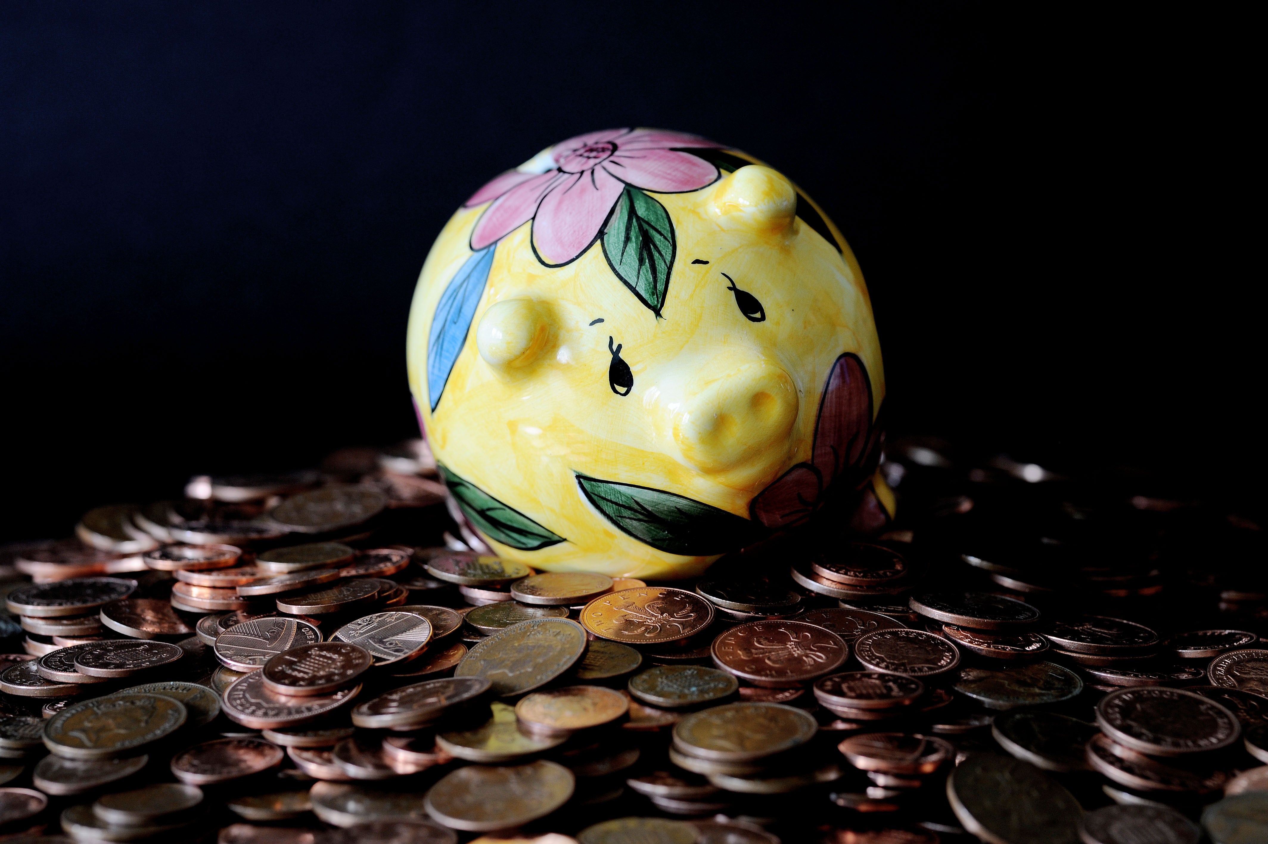 A piggy bank on a pile of coins