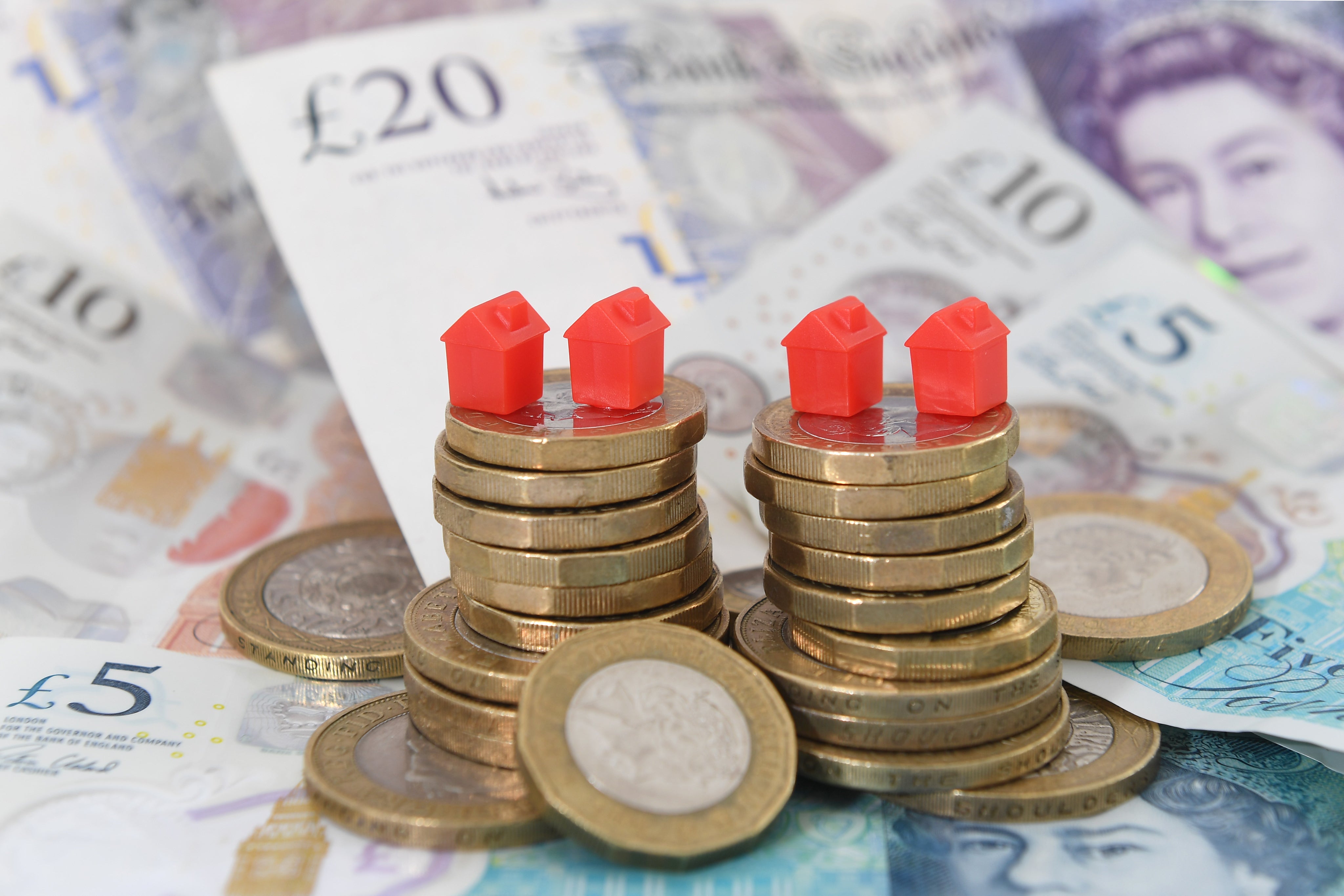 Models of houses on top of coins and banknotes