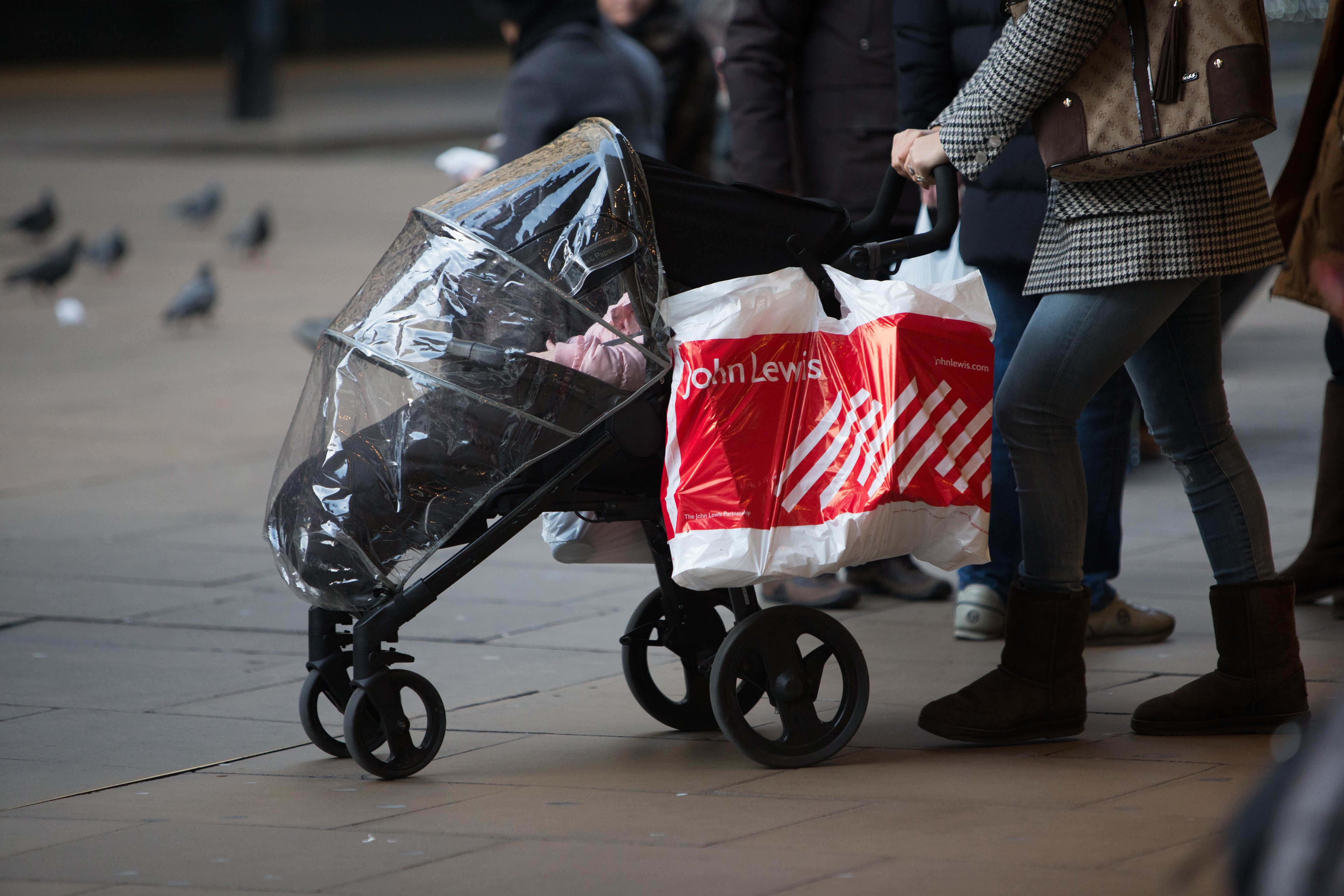 A woman with a John Lewis shopping bag