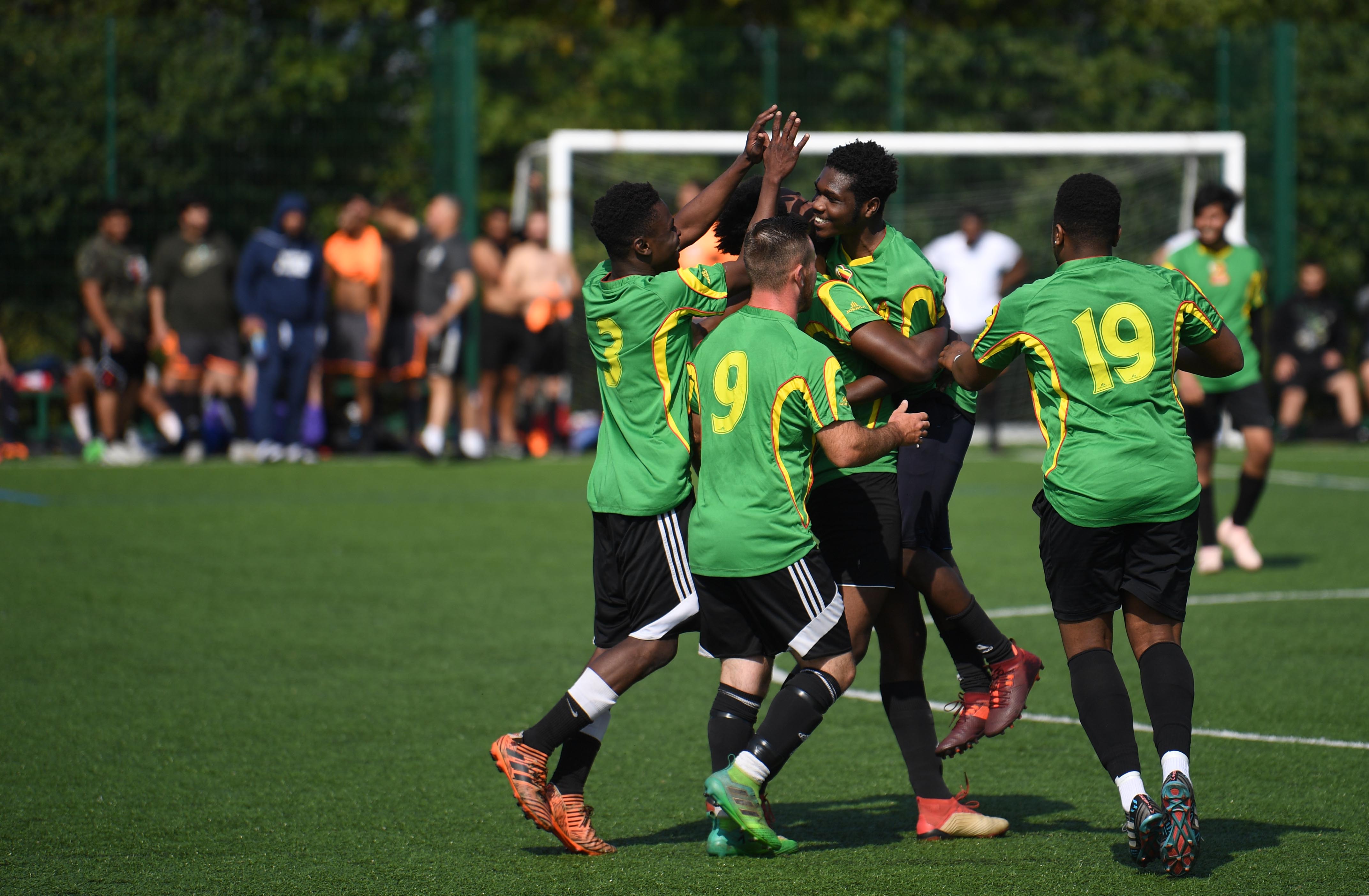 Sanctuary Strikers Football Club players celebrate scoring a goal against Reading Reserves