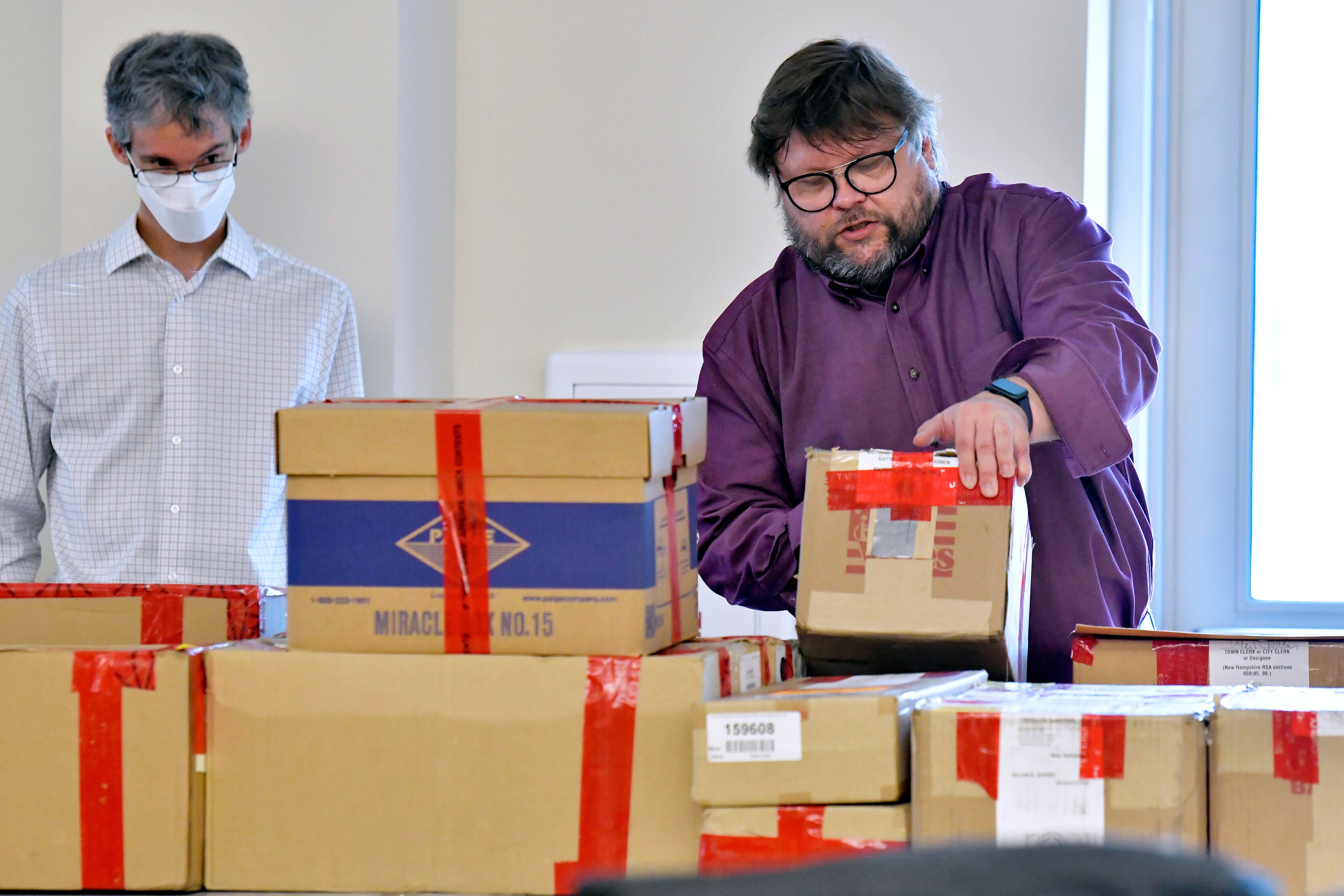 File image: Election auditors Harri Hursti, right, and Mark Lindeman, catalog ballot boxes in Pembroke, New Hampshire, during a forensic audit of the 2020 New Hampshire legislative election. Auditors have found no evidence of fraud or political bias in the controversial New Hampshire election that has drawn the interest of Donald Trump