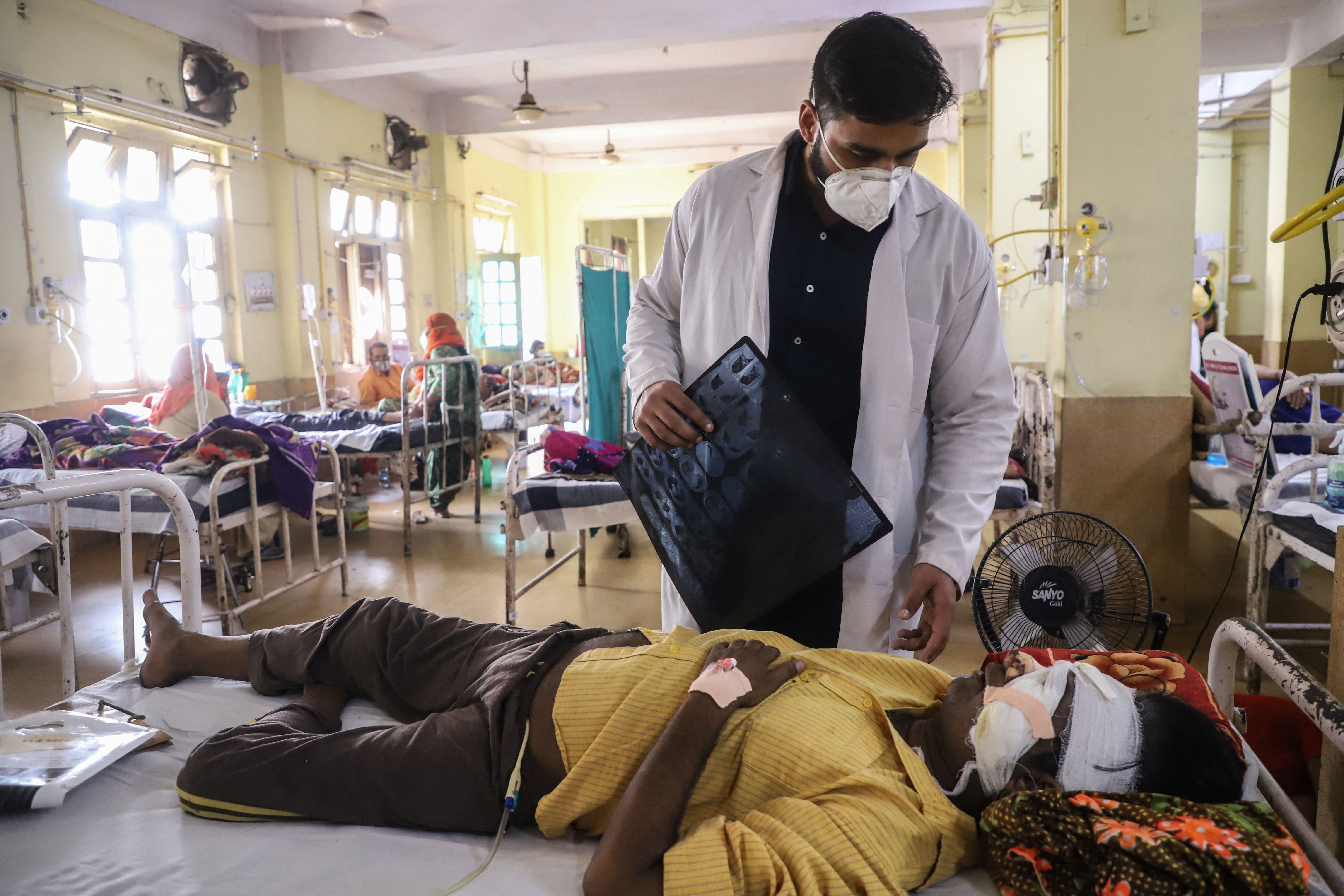 A doctor assists a Covid-19 coronavirus patient with Black Fungus, a deadly and rare fungal infection